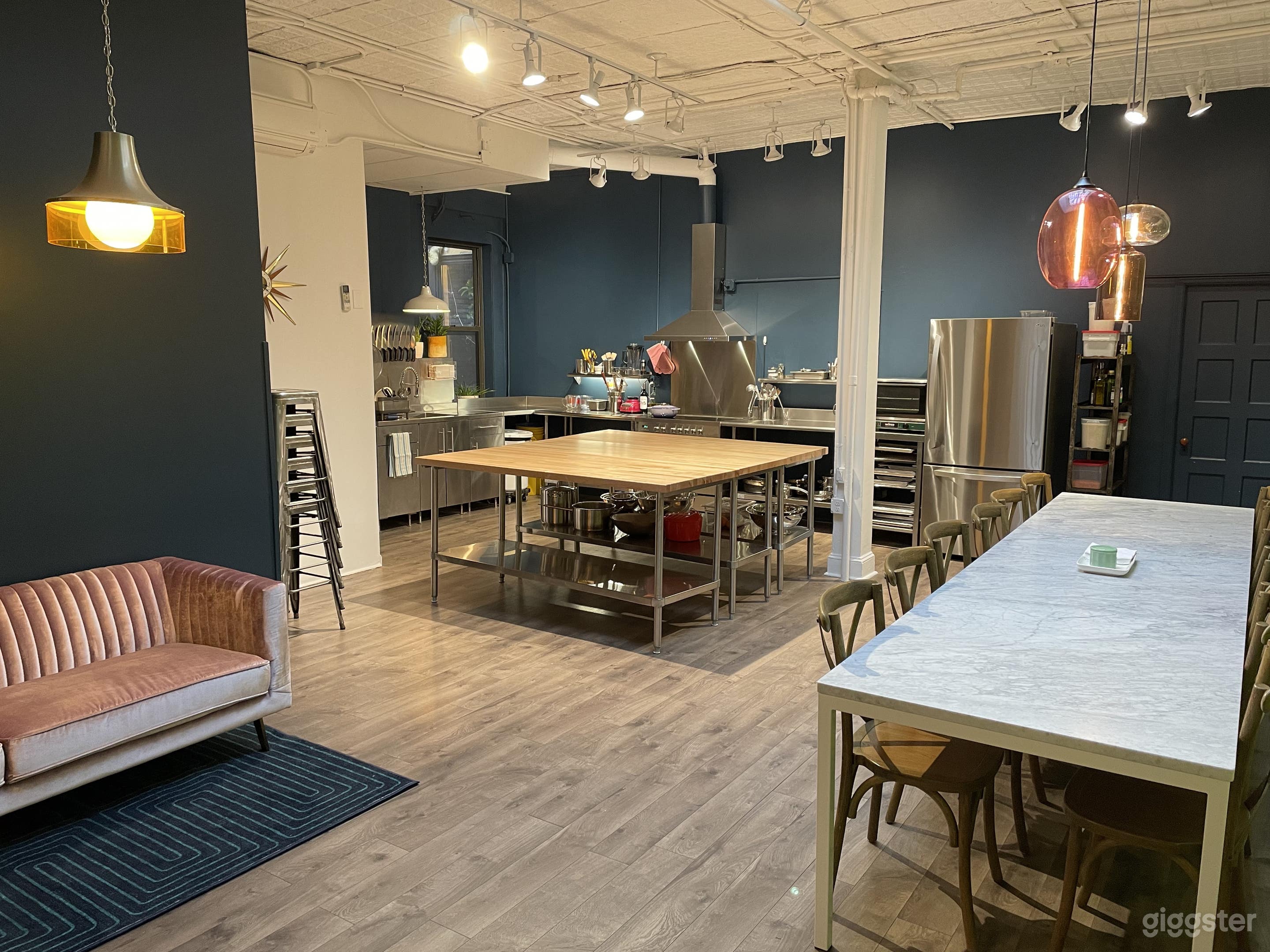 Full loft view with kitchen, dining table, and lounge area