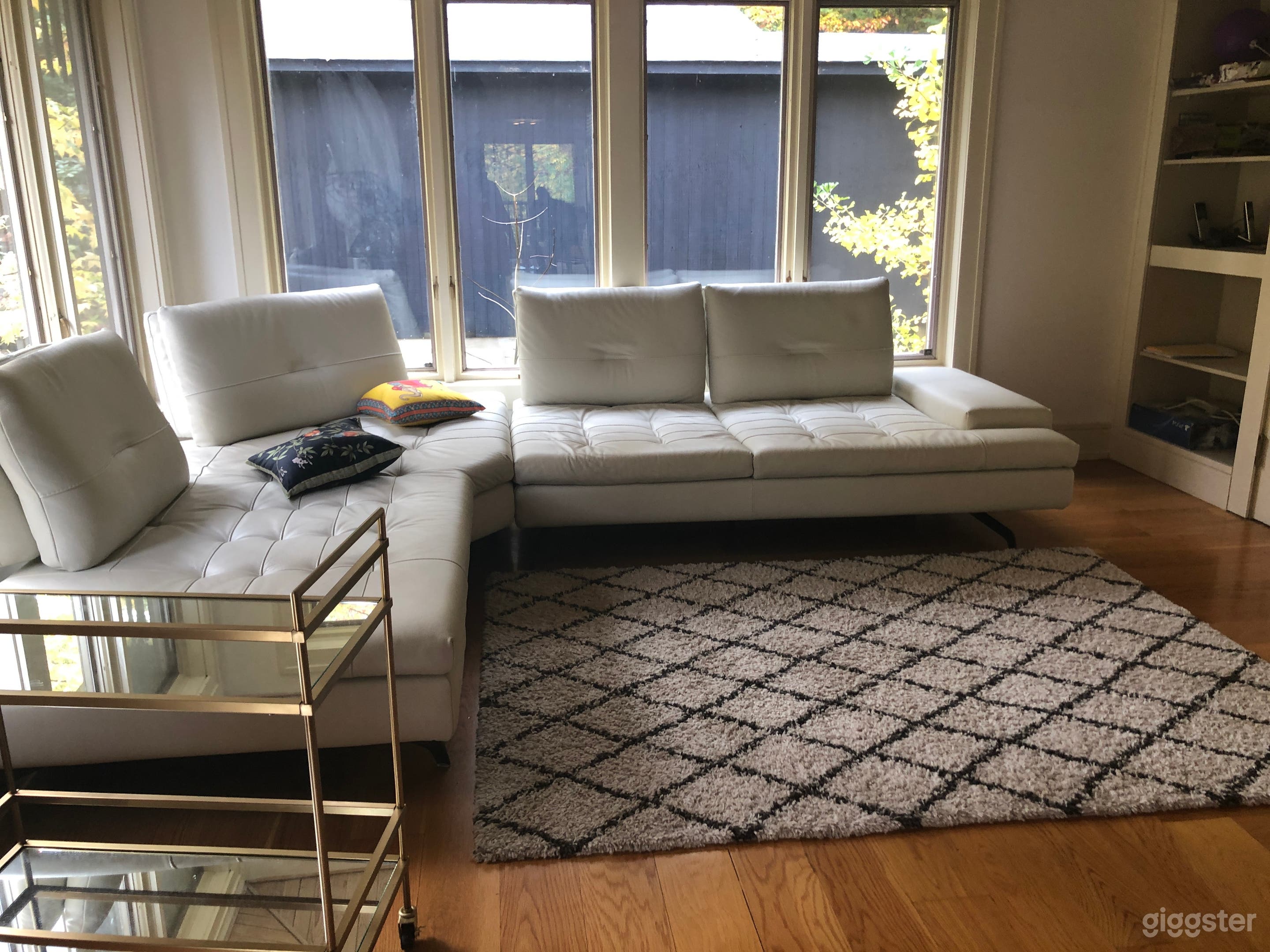 Family room with series of wide windows overlooking bluestone patio. Fun birdwatching 