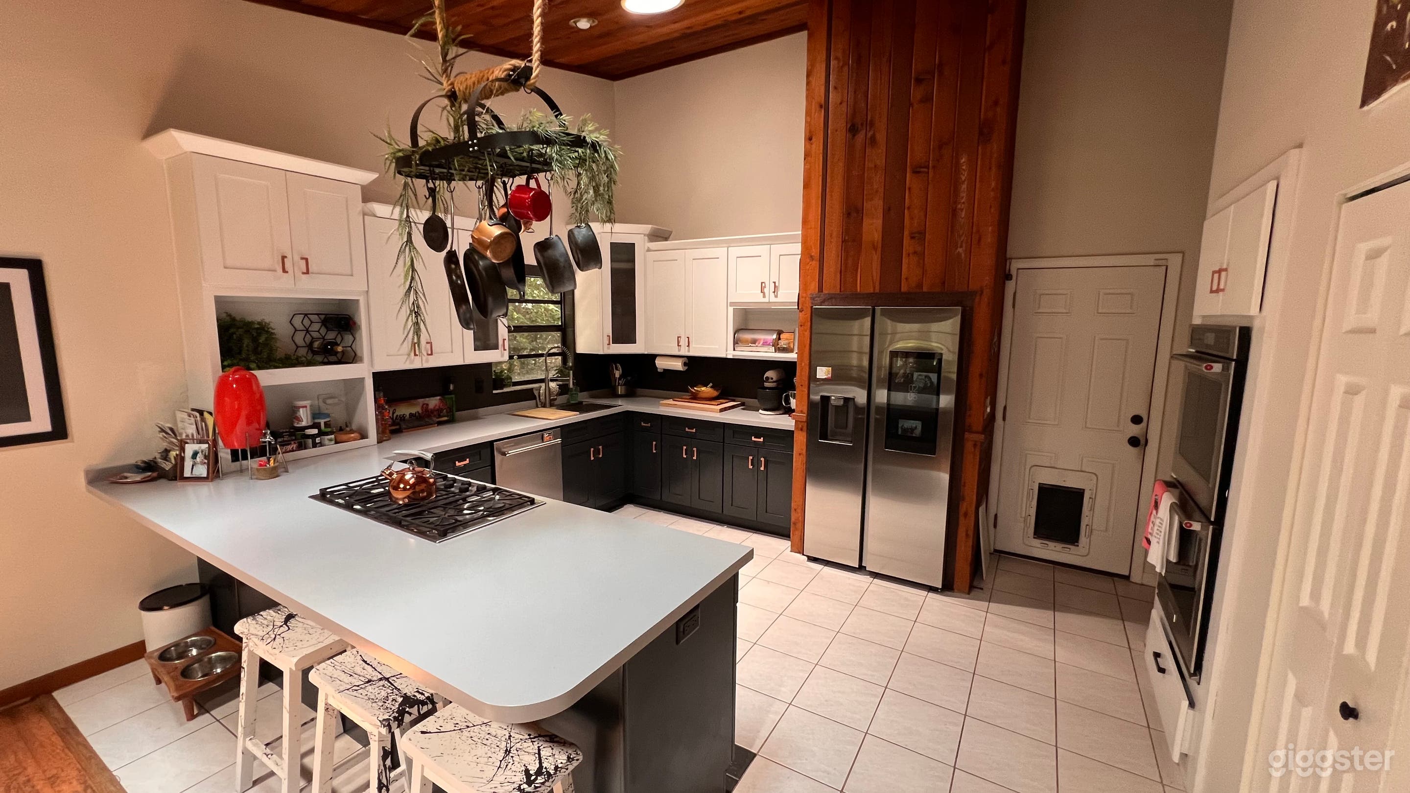 Dated kitchen with modern upgrades and unique art piece for hanging pots