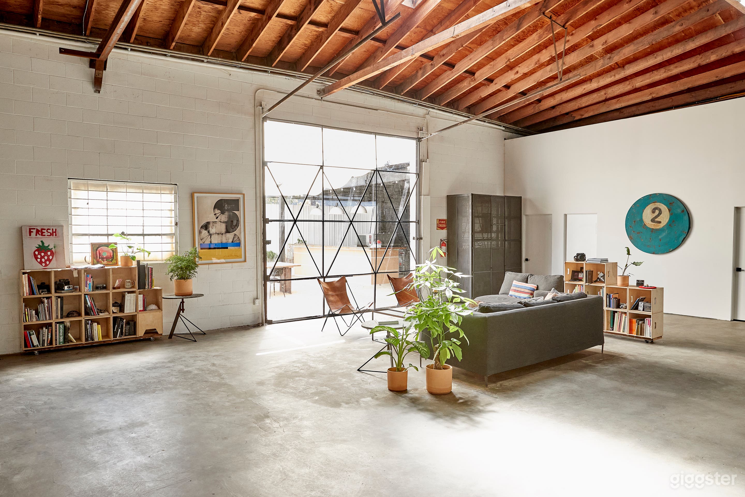 client lounge area with glass wall overlooking outdoor dining area