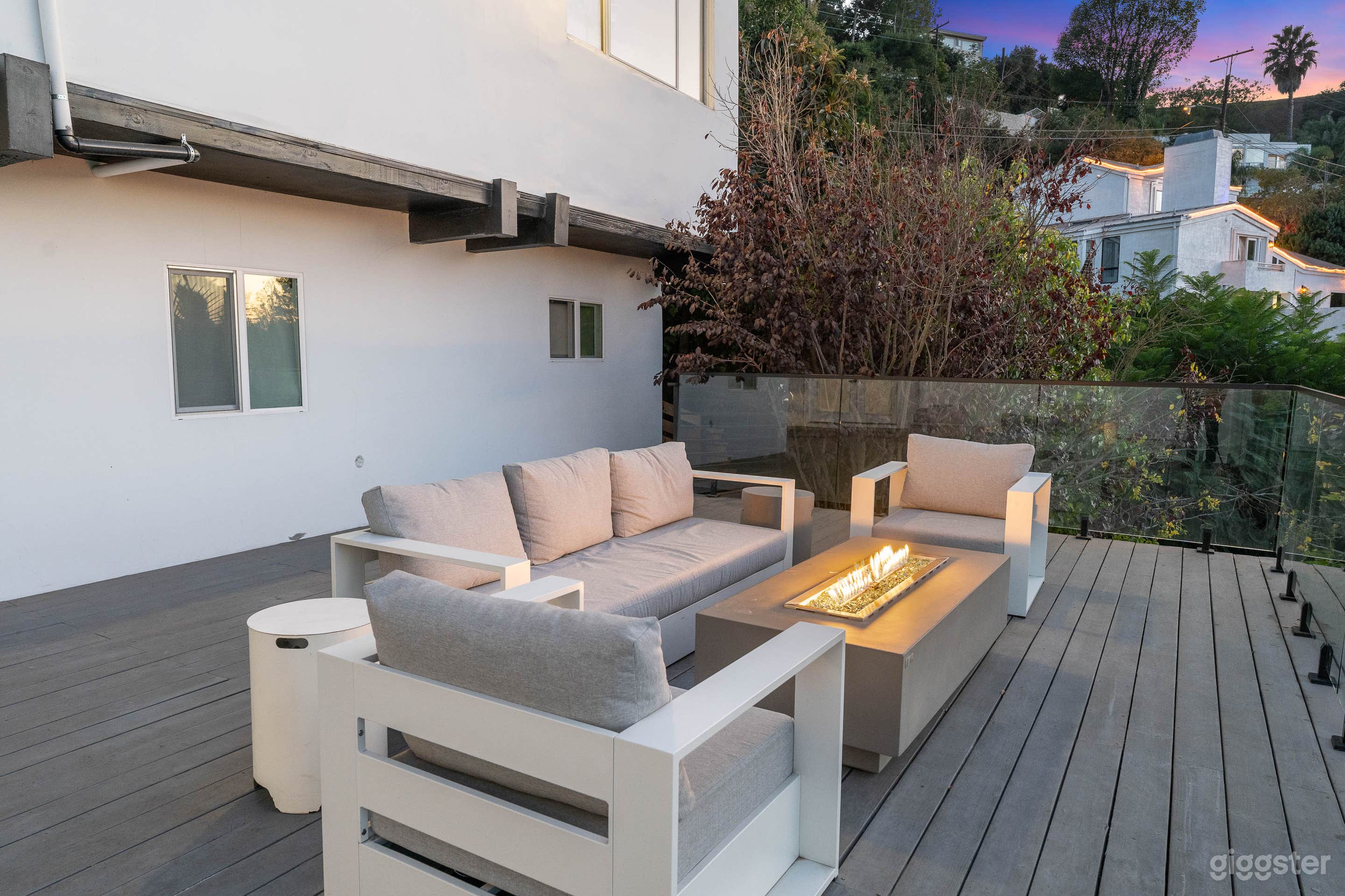 Outdoor furniture includes a fire pit, sofa, and 2 seats.  