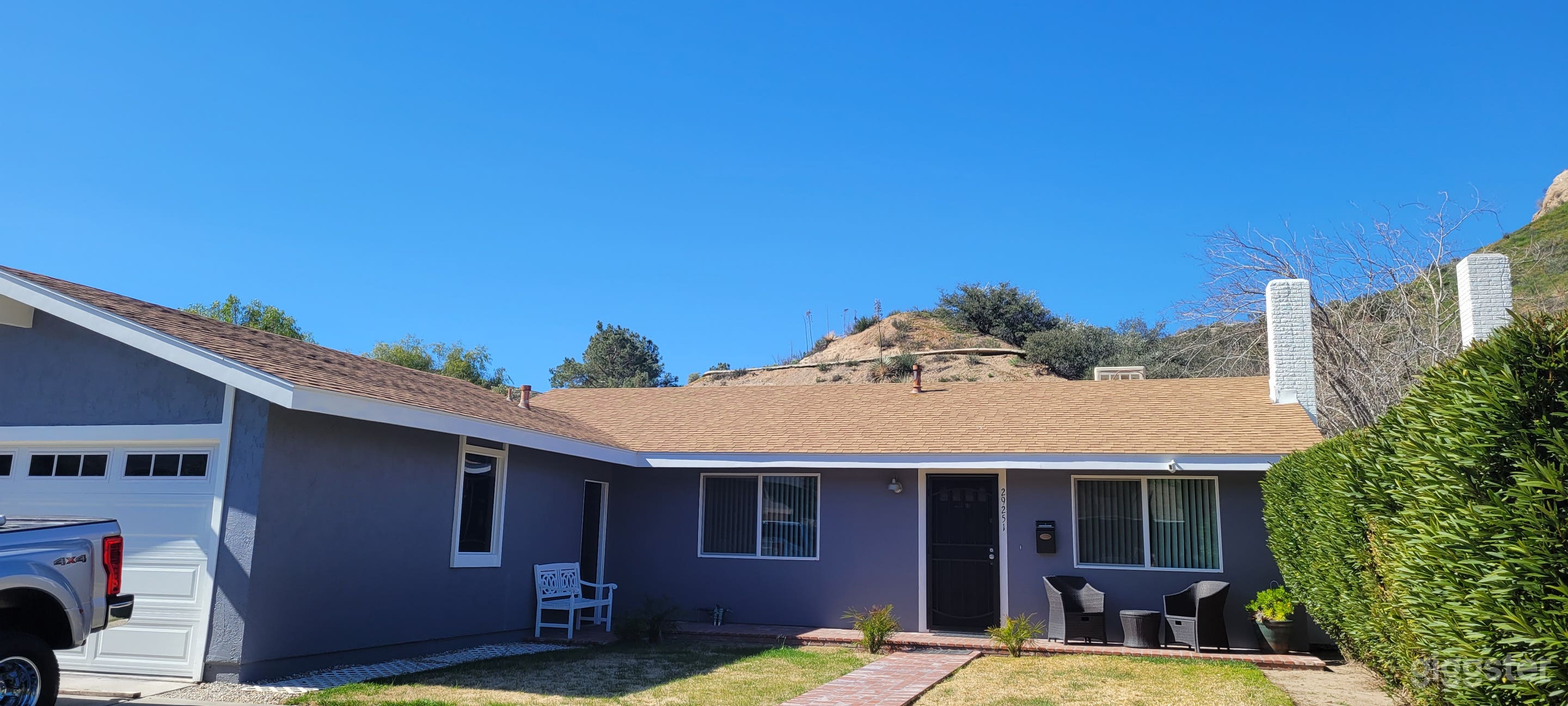 Hillside front view of home w/garage connected, no entry door to inside of home.