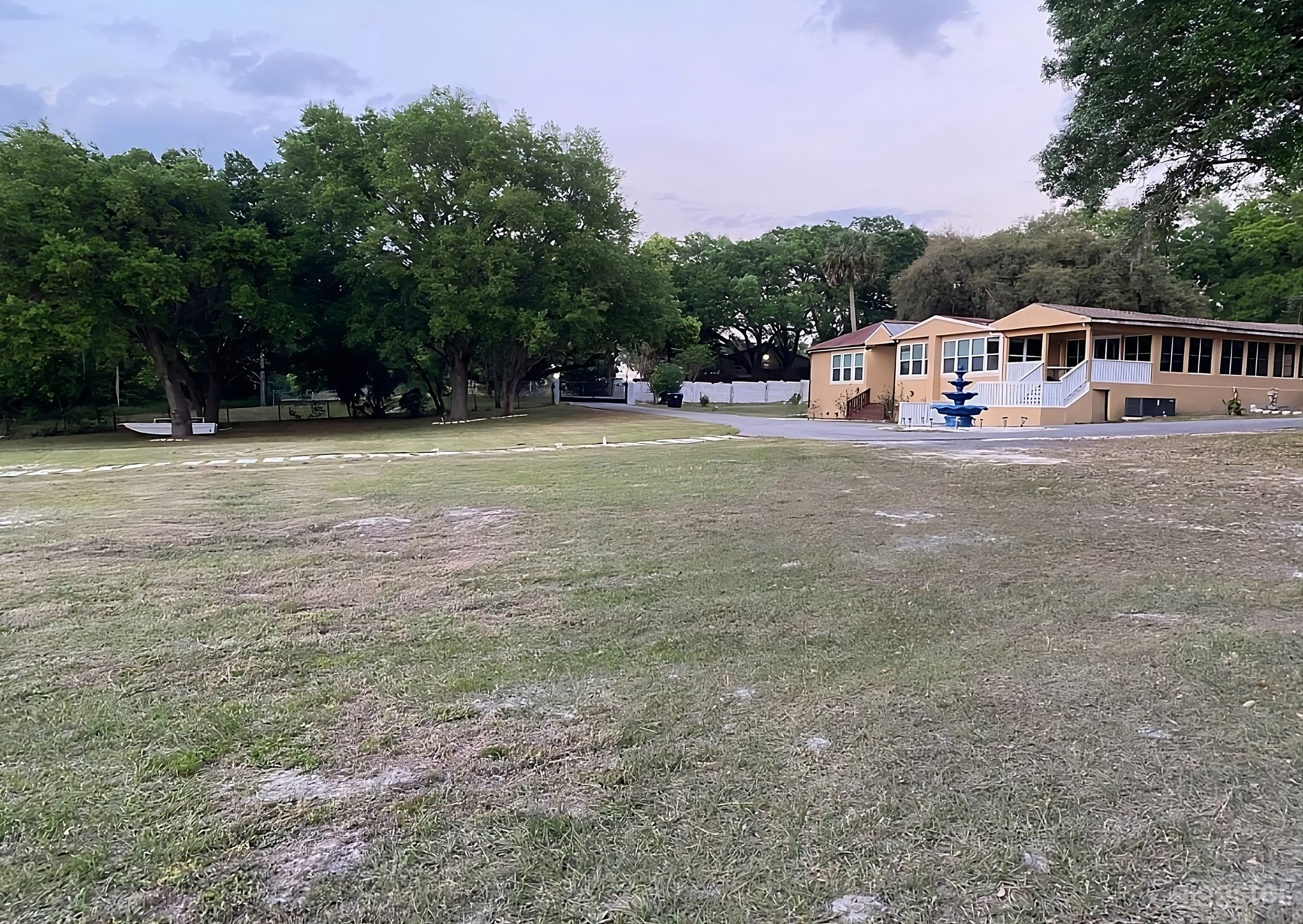 Spacious Backyard Featuring Fountain and Shady Oaks Photo 3