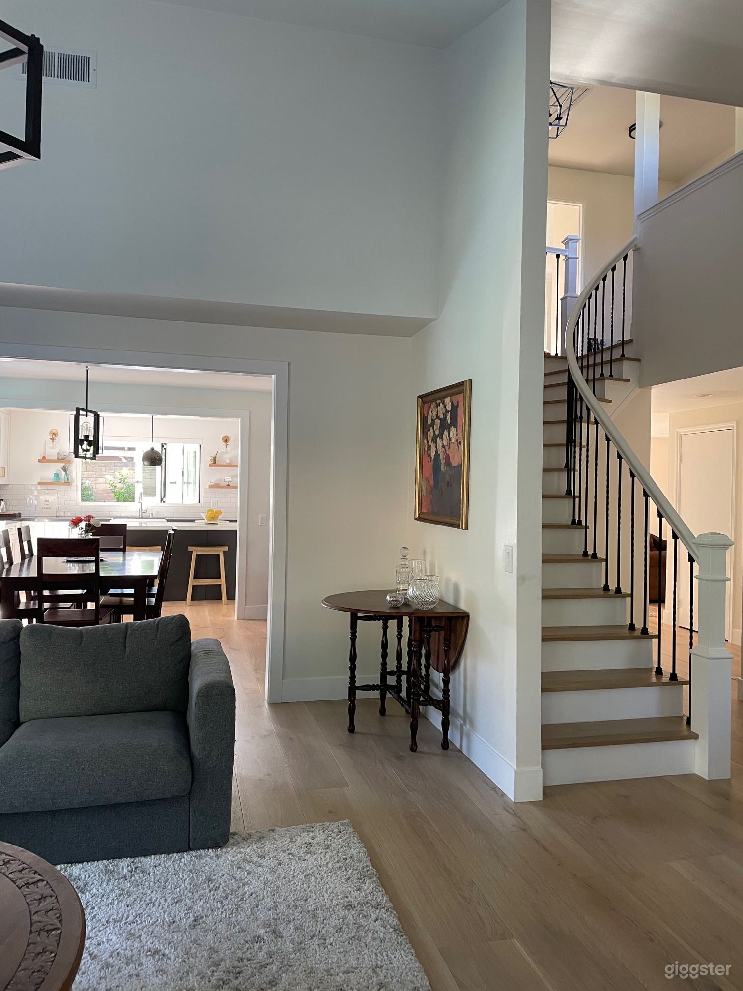 A curved staircase leads from the foyer up to six bedrooms and three baths.