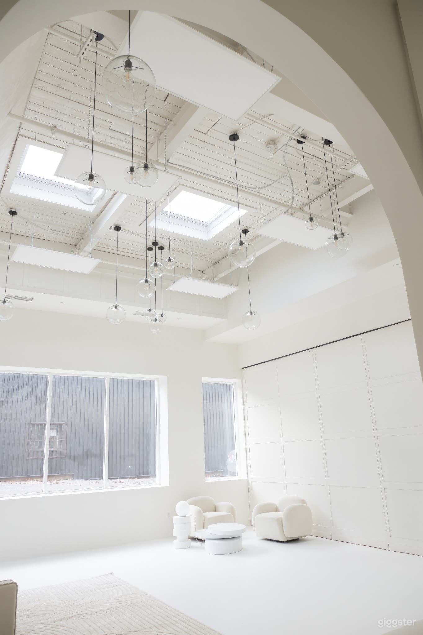 Spacious white photo studio with impressive 17 ft ceiling height, ideal for capturing stunning shots

