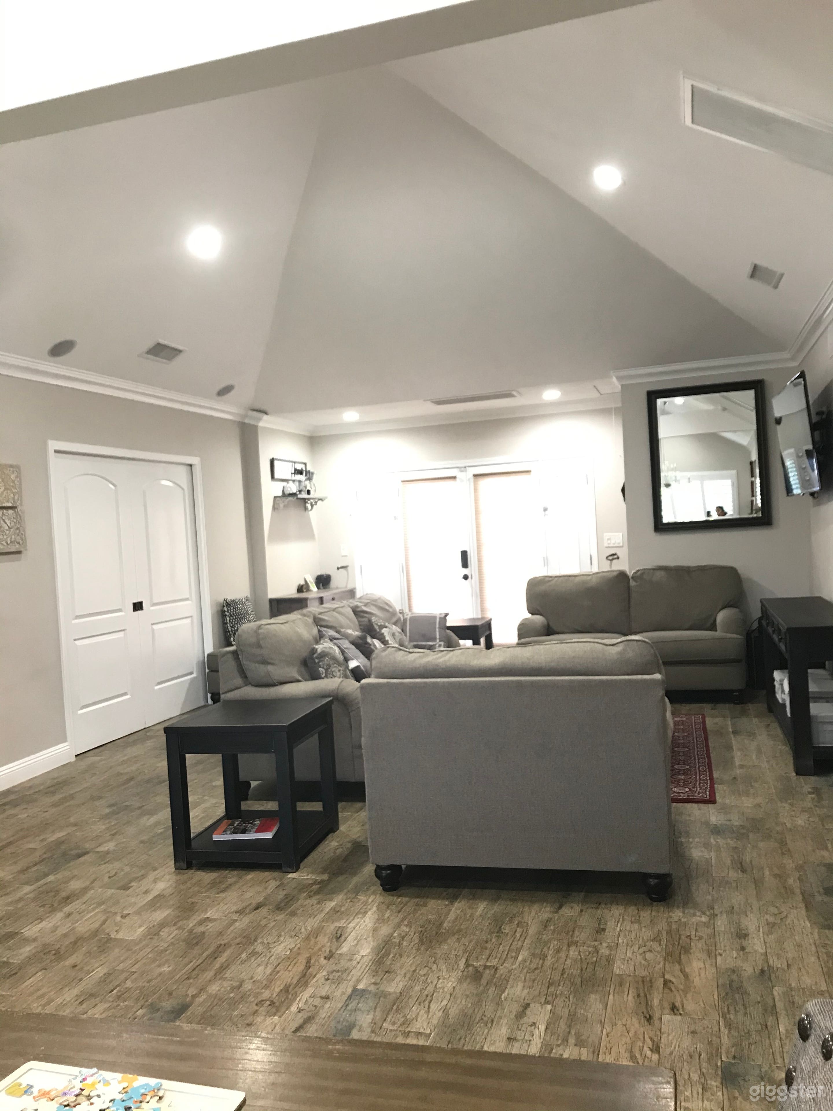 Living room with Electric fireplace and high ceiling.
