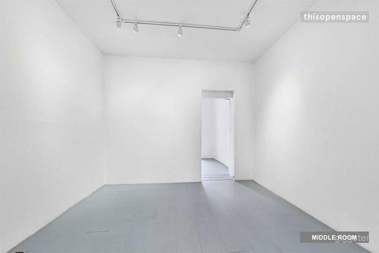  View of the second smaller room from the big front room. Adjustable track lighting and pocket door at the back that can be left open or closed. 