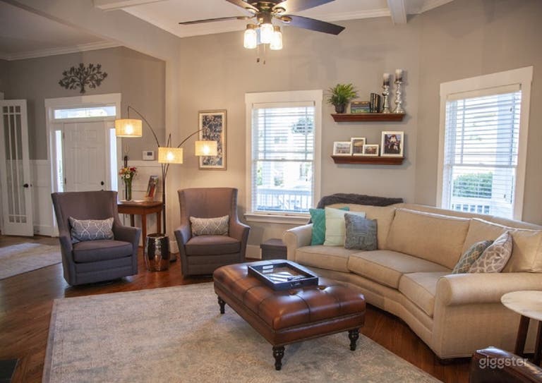  Unique angled living room with custom made conversational couch. 