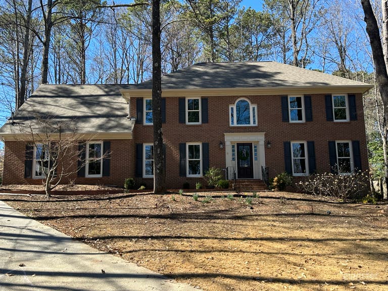  1980s brick with patio and big wooded backyard! 