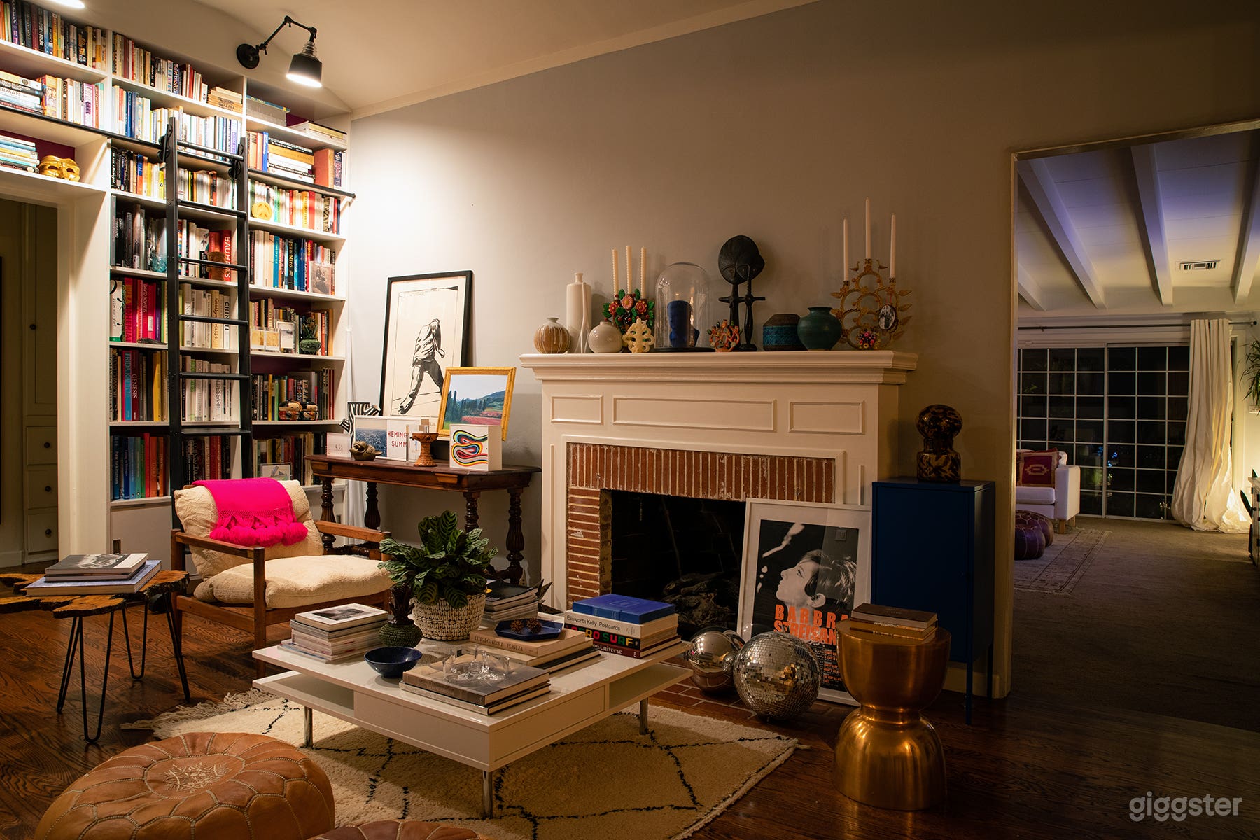 Library Sitting Room with Fireplace + Built-In Bookcase with Ladder (Night)