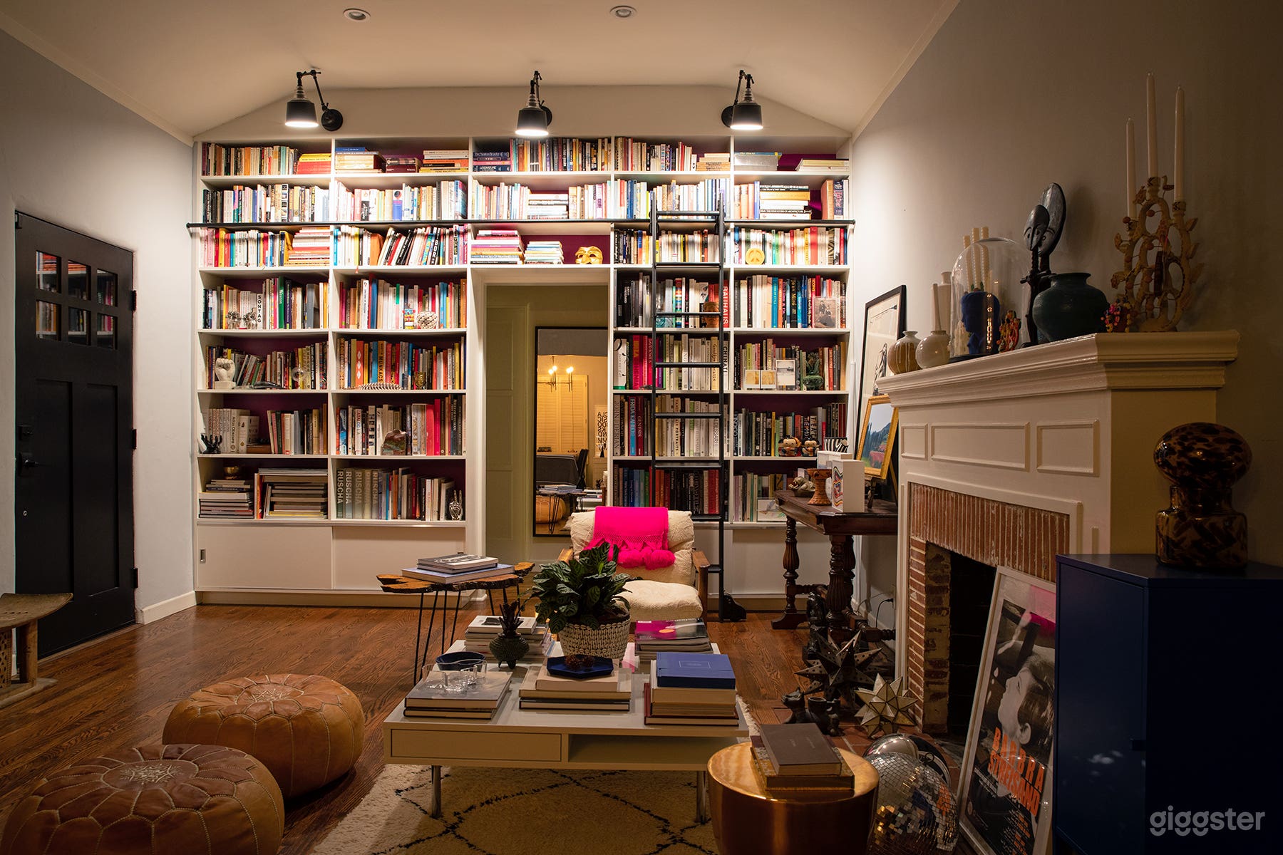 Library Sitting Room with Fireplace + Built-In Bookcase with Ladder (Night)