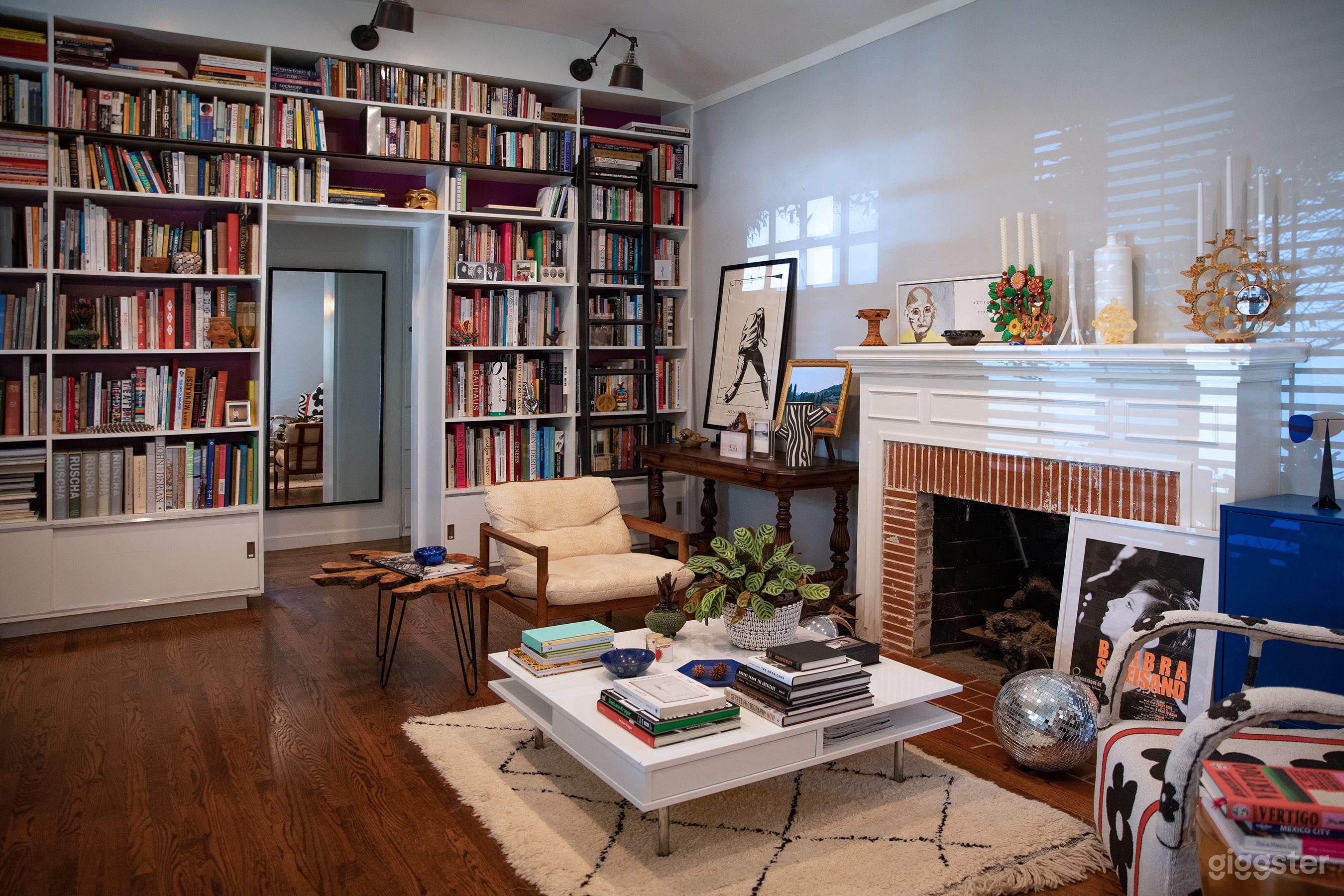 Library Sitting Room with Fireplace + Built-In Bookcase with Ladder (Day)