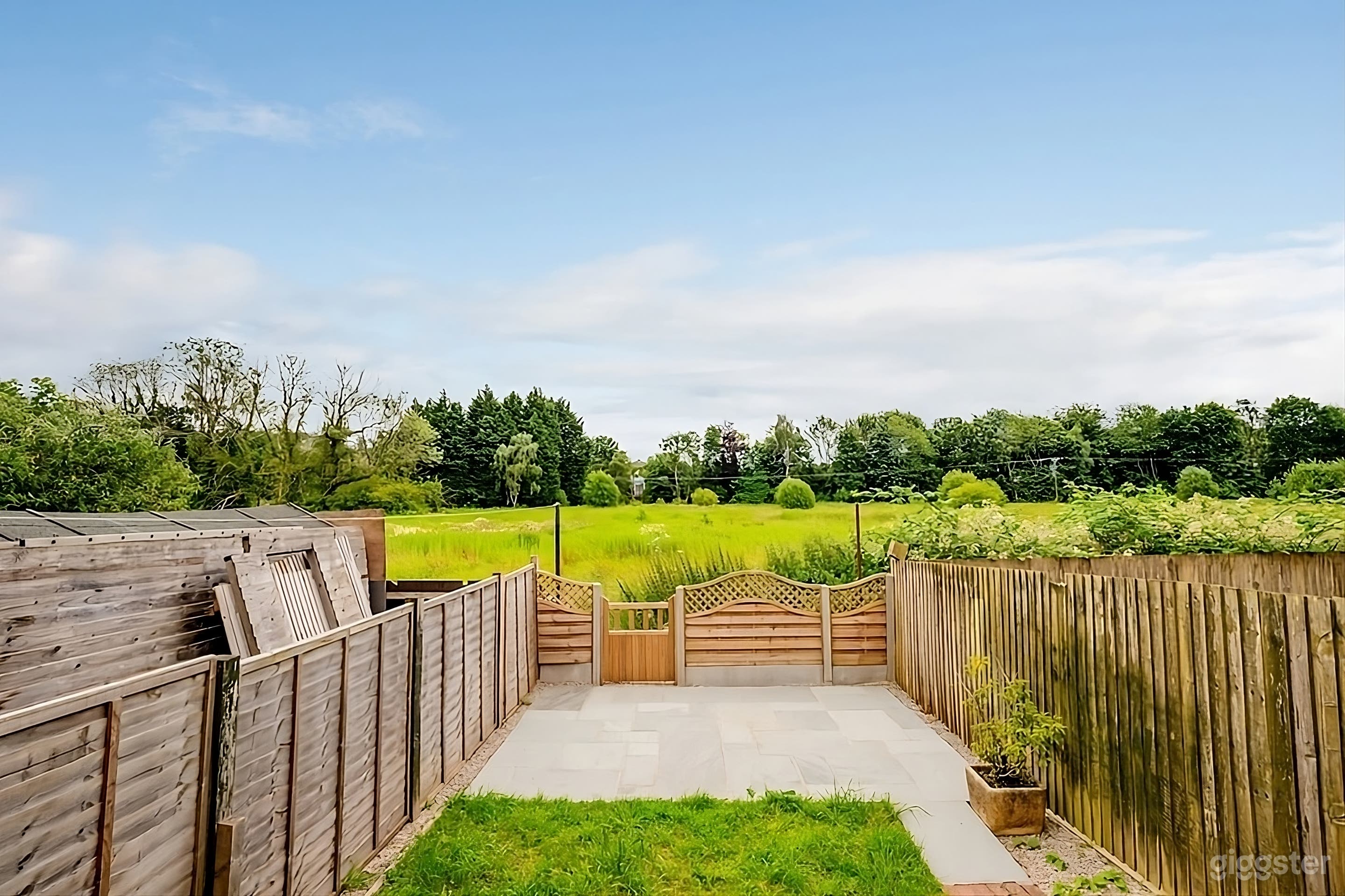 Private Backyard with Patio and Green Space Photo 1