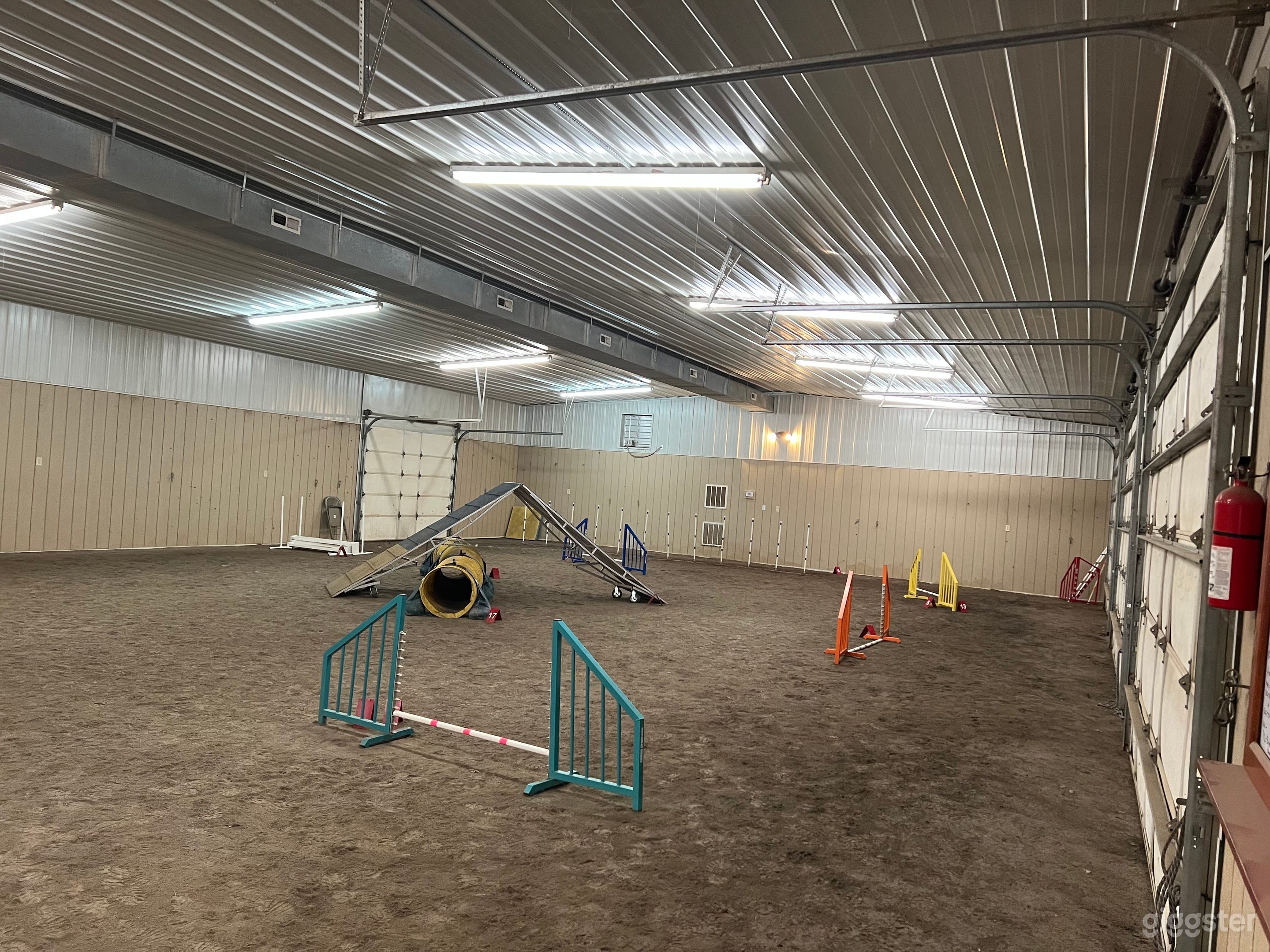 Interior 50x75 building showing fourth garage door to rear. Picture taken from pedestrian door.