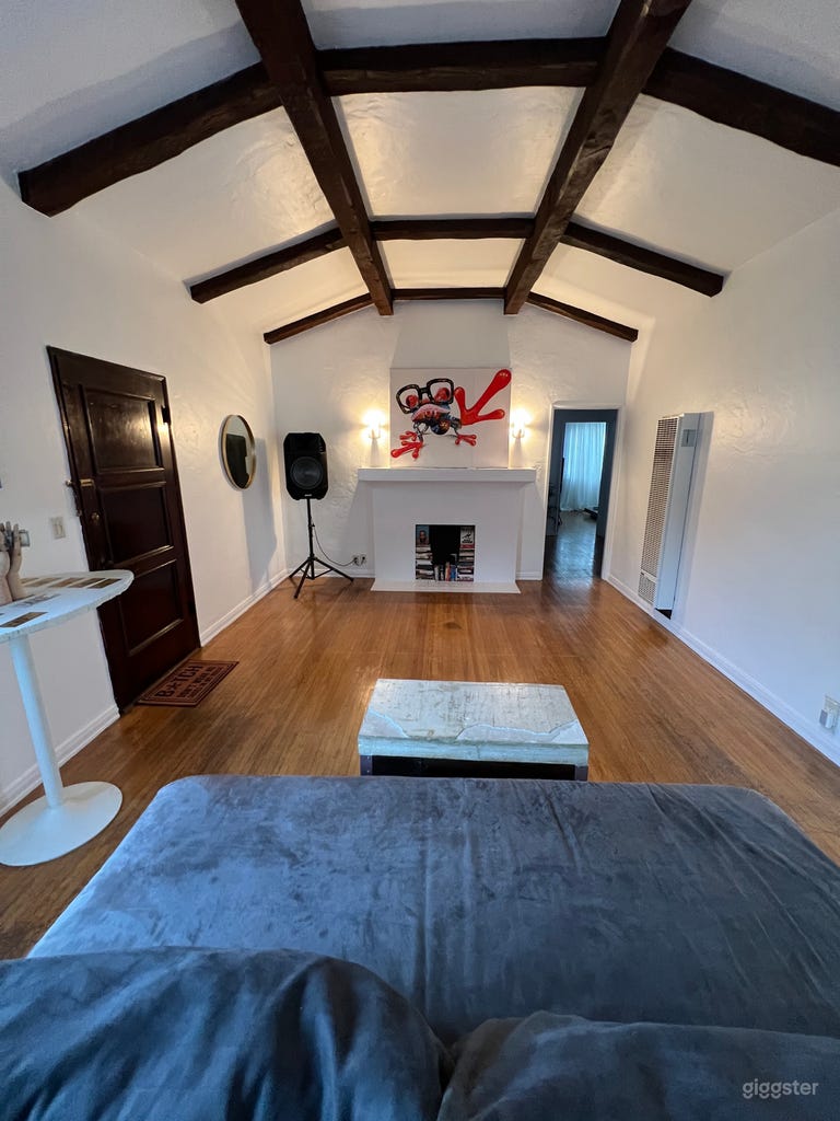  Large living room with surround sound speakers. 