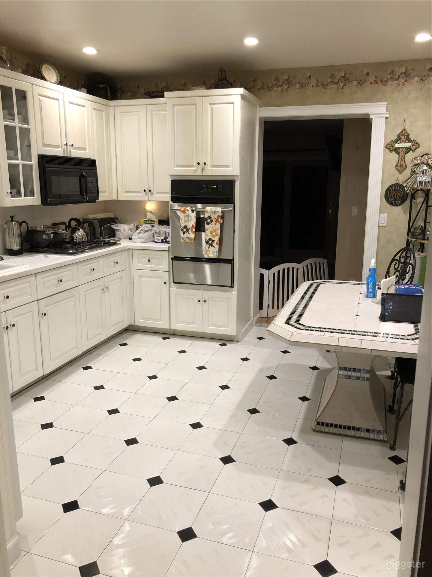 White kitchen leading to dining room and bathroom
