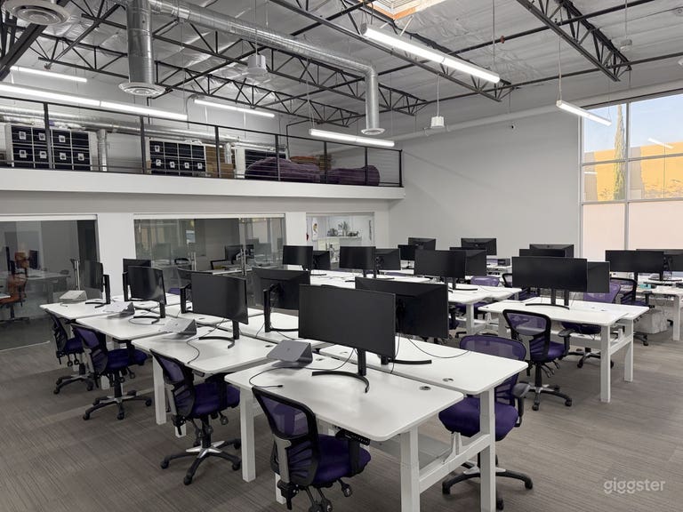  Bullpen with stand-up desks and ultra-wide monitors 