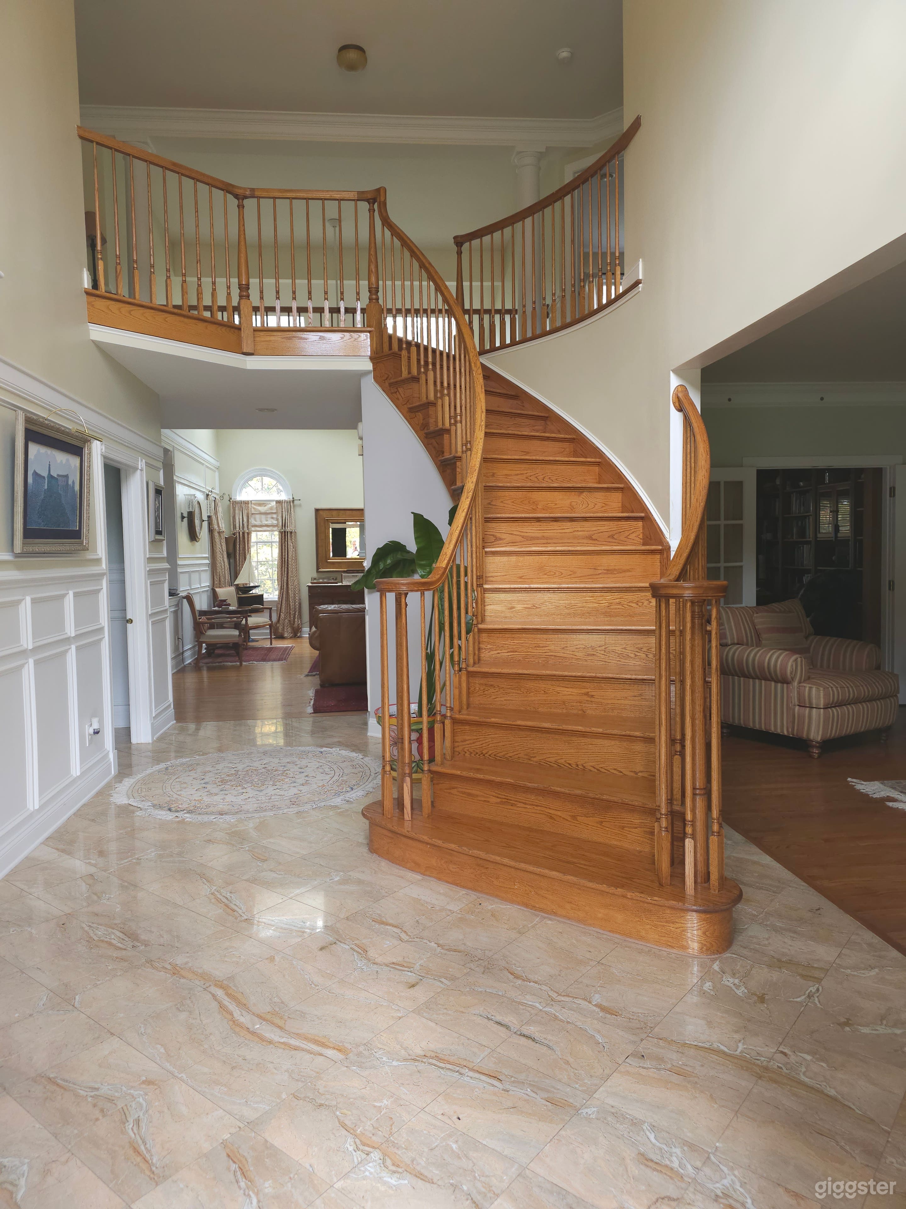 Center hall with curved oak staircase and marble floor