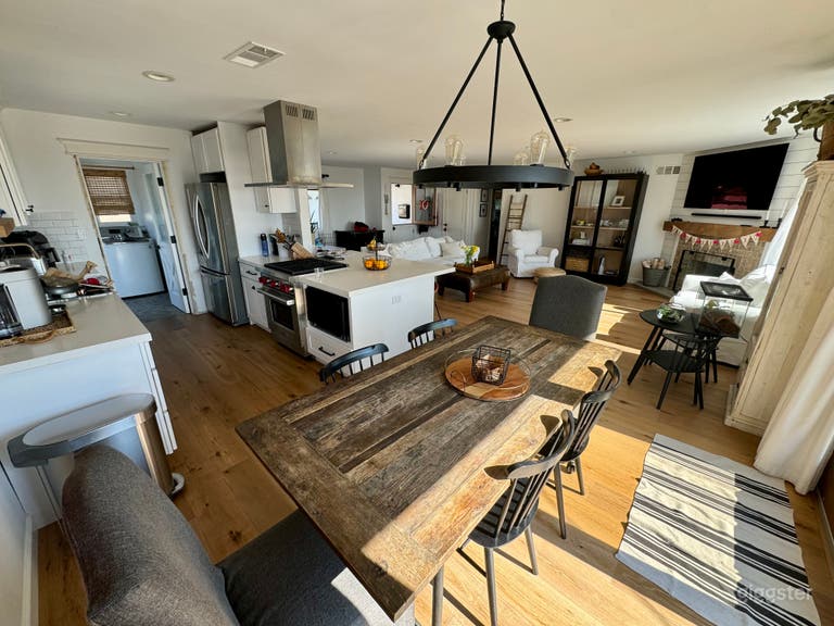  Open concept kitchen and living room with quarts peninsula and Wolf Stove.  