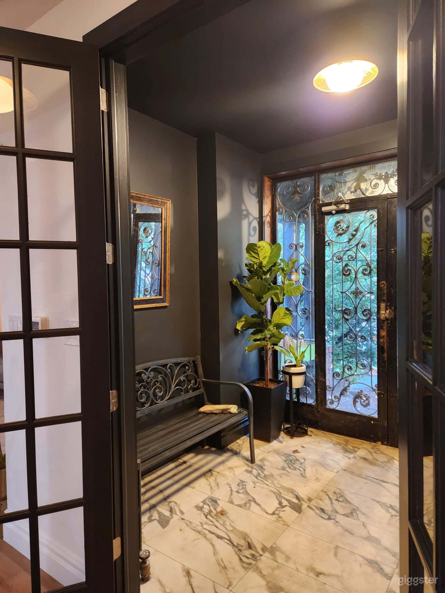 Oversized Vestibule
with ornate exterior door
and paneled french interior door