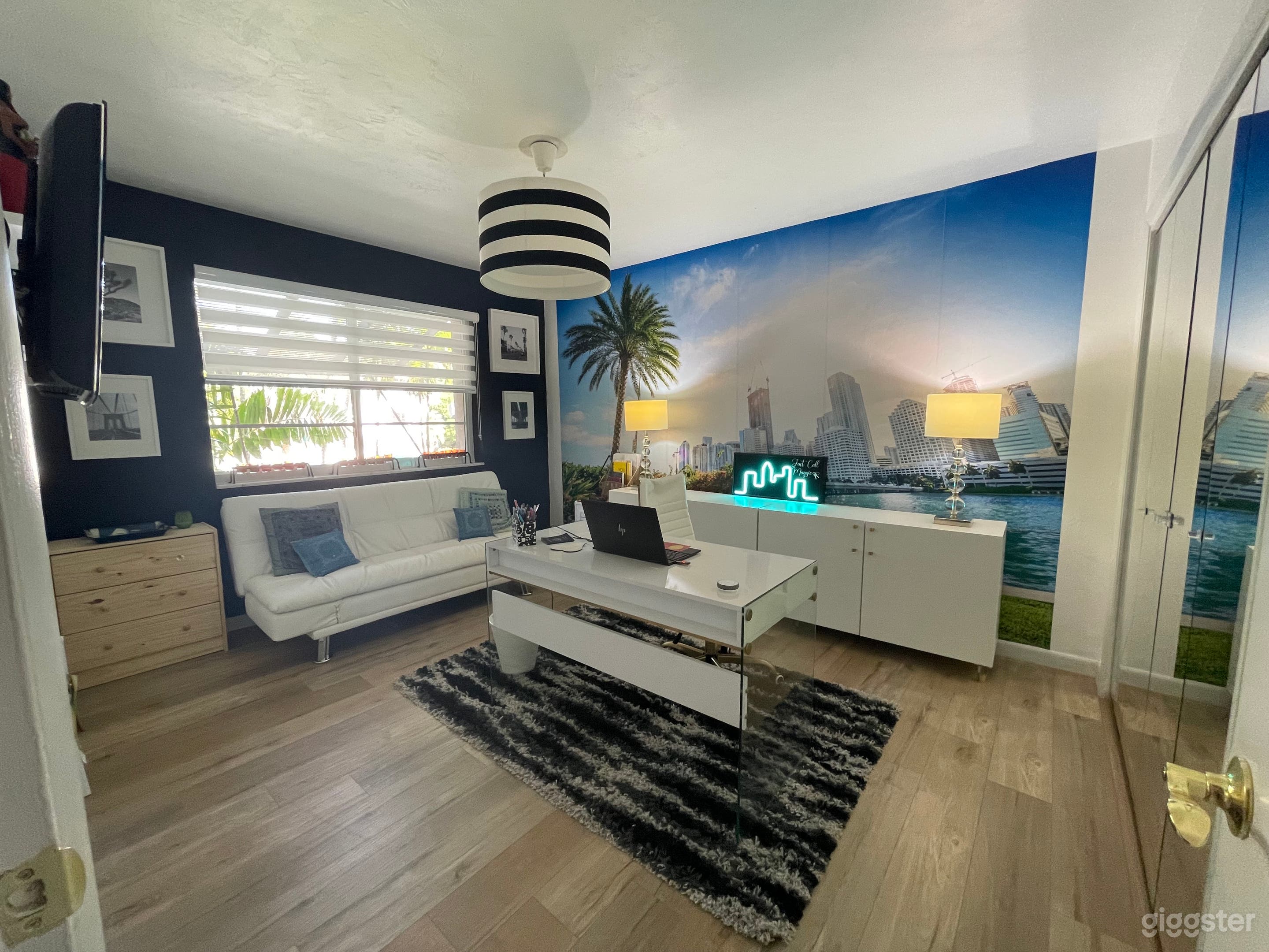 Office type setting with Miami backdrop.