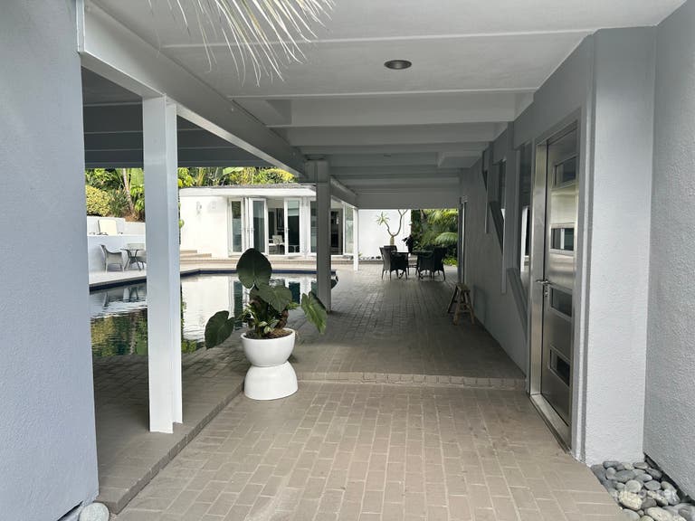  Dramatic pool, main house entrance and cabana view as one enters the steel and glass main entrance doors. 