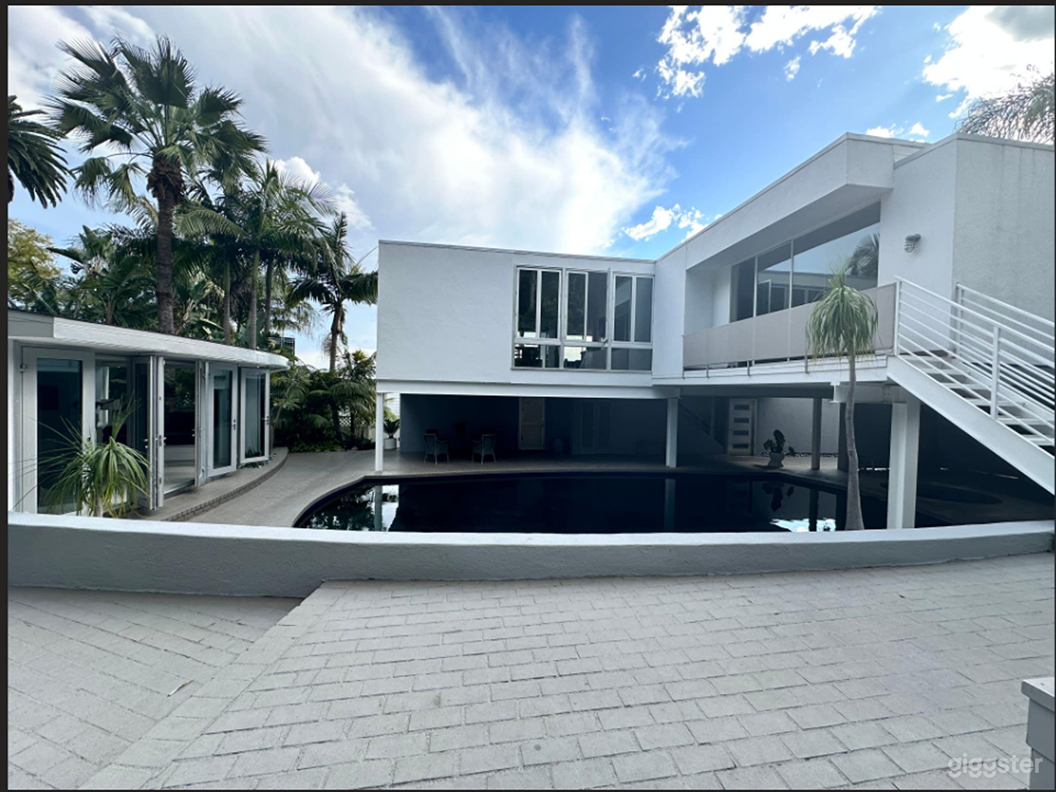 A view of the cabana and main house.  The cabana has lovely tropical and pool views while the main house has West Hollywood views towards Catalina Island which comes into view on a clear day. 