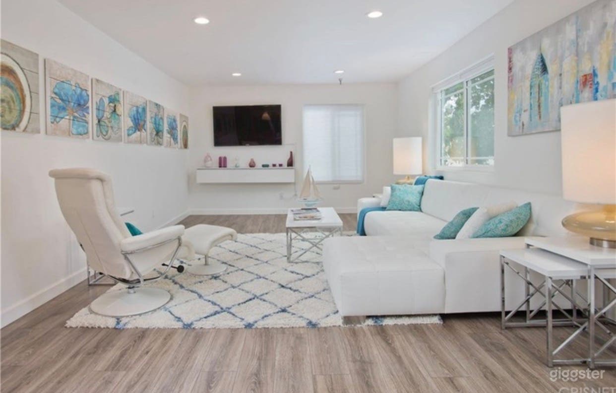 Enjoy a beach front upscale Hamptons vibe in this designer finished living room