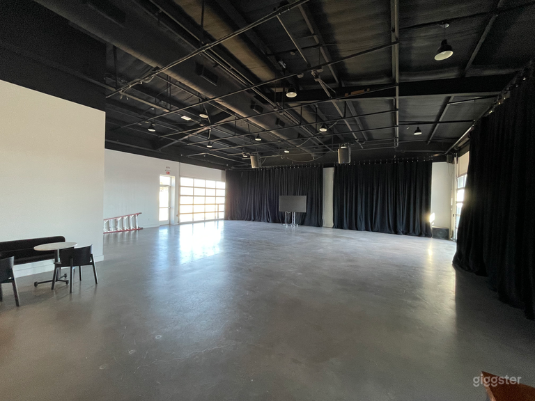  Concrete floors and glass garage doors, with white walls behind the curtains. 