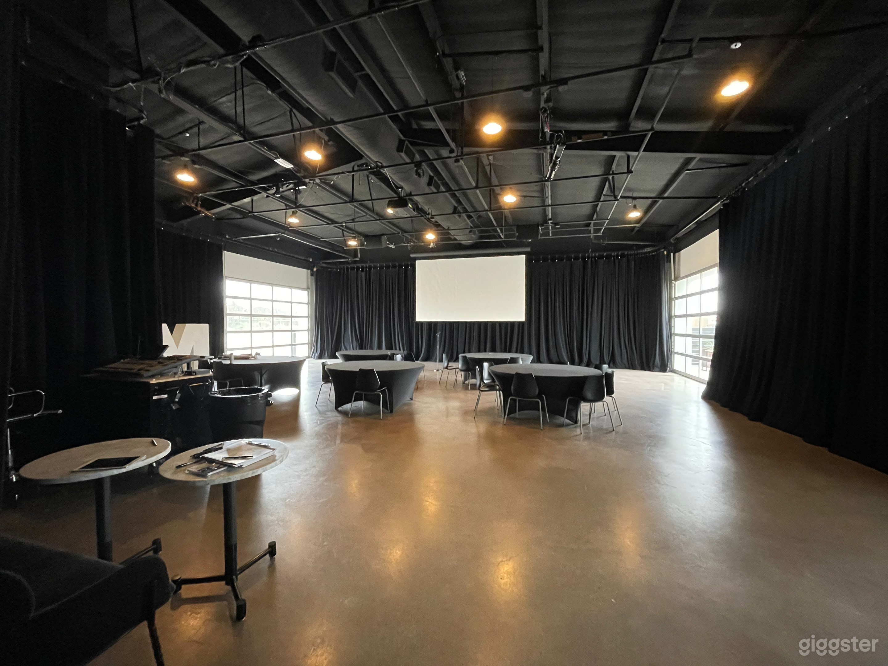 Behind the curtains we have exterior glass garage doors for natural light if needed.