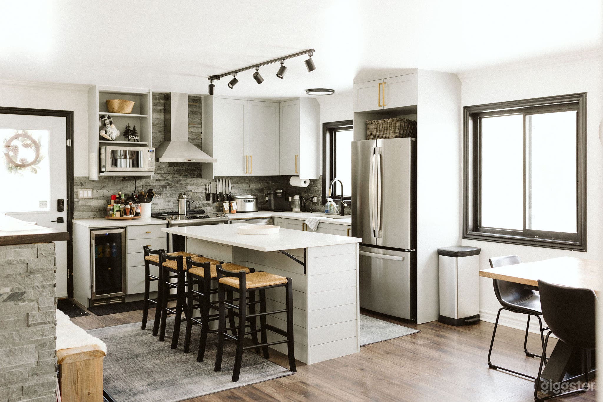 Fully stocked kitchen with brand new stainless steel appliances, bar fridge and island seating for 4