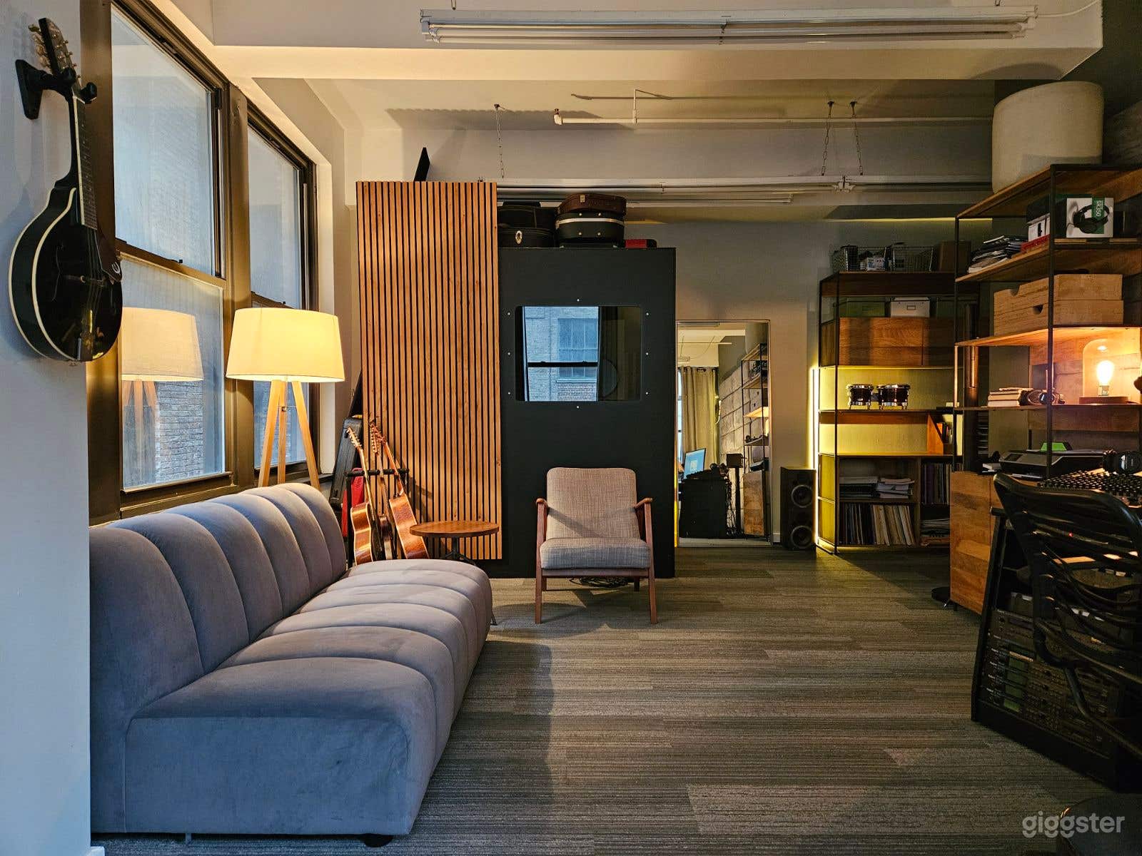 The room comfortably fits about 7 people. And the hallway is spacious; I've had hair and make-up teams set up just outside the studio, and it works great.