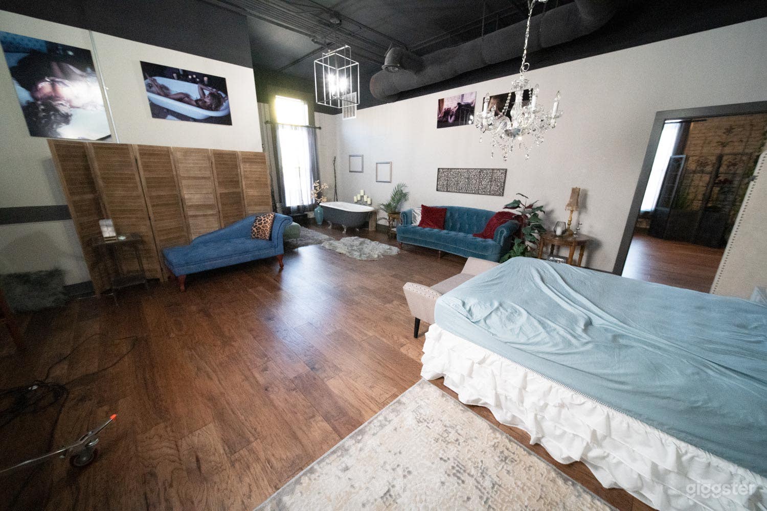 Wood floors, high black ceiling, multiple sets