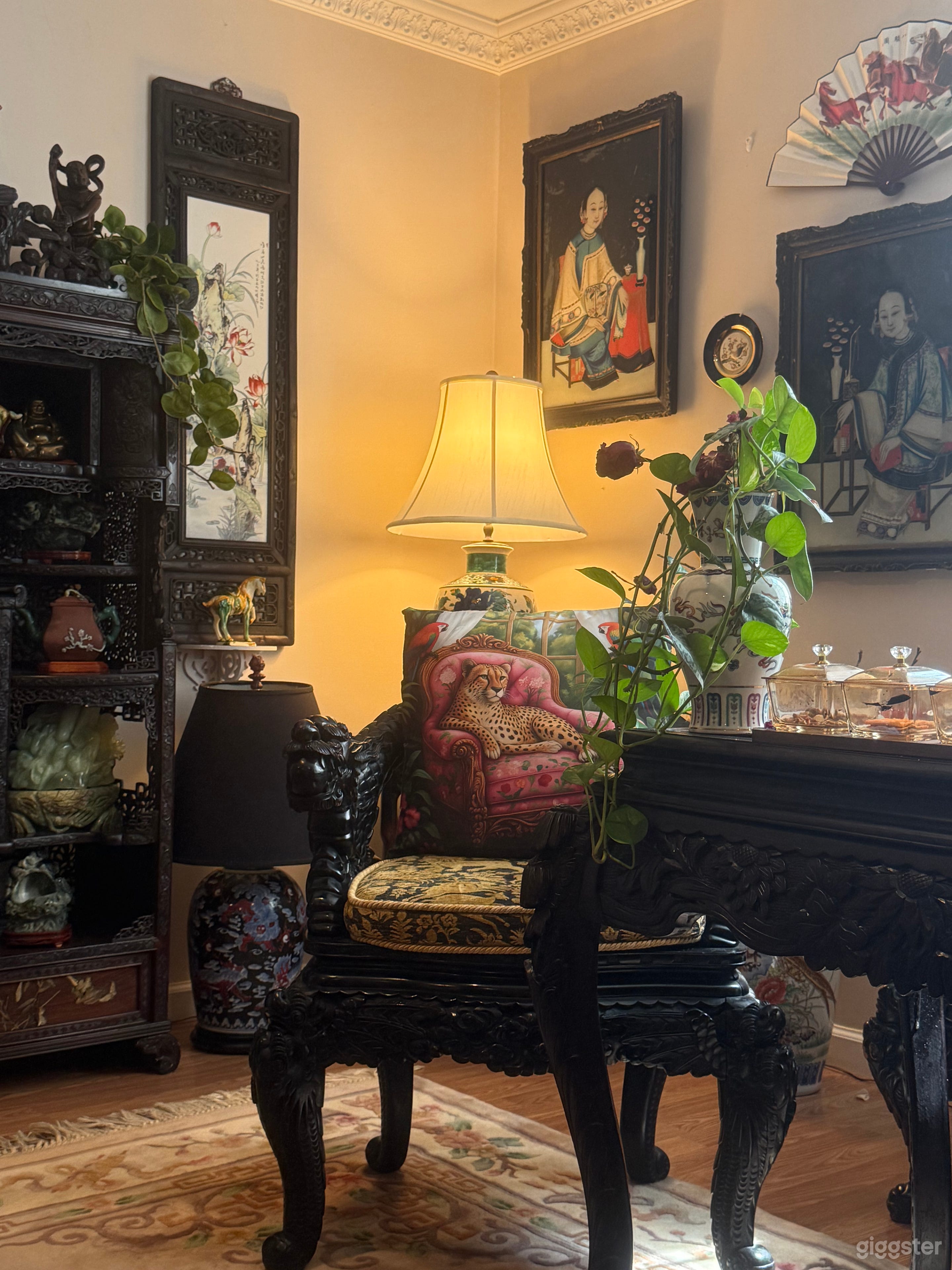 Antique glass paintings over 150 years old, rosewood furniture, and a majestic dragon throne set a regal tone. Warm lamplight illuminates a calligraphy desk, ready for brushwork. Ideal for cultural events, editorial shoots, or private gatherings