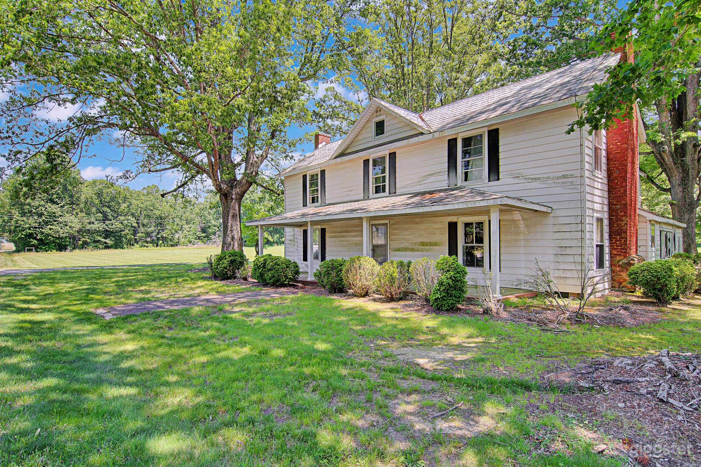 Two-story 1850s farmhouse with original details like built-ins, delicate glass doors and light fixtures. 