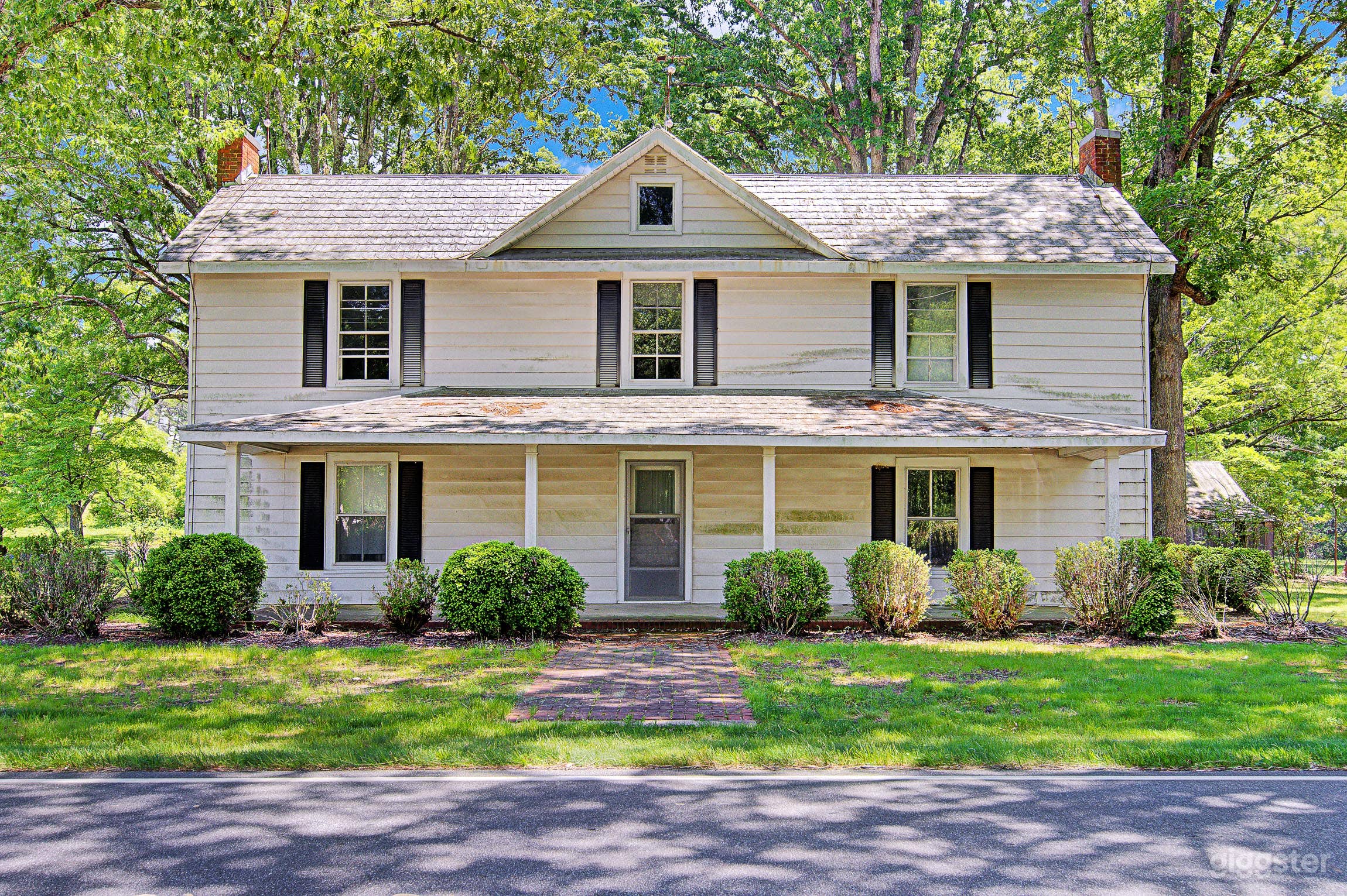 Two-story 1850s farmhouse with original details like built-ins, delicate glass doors and light fixtures.  