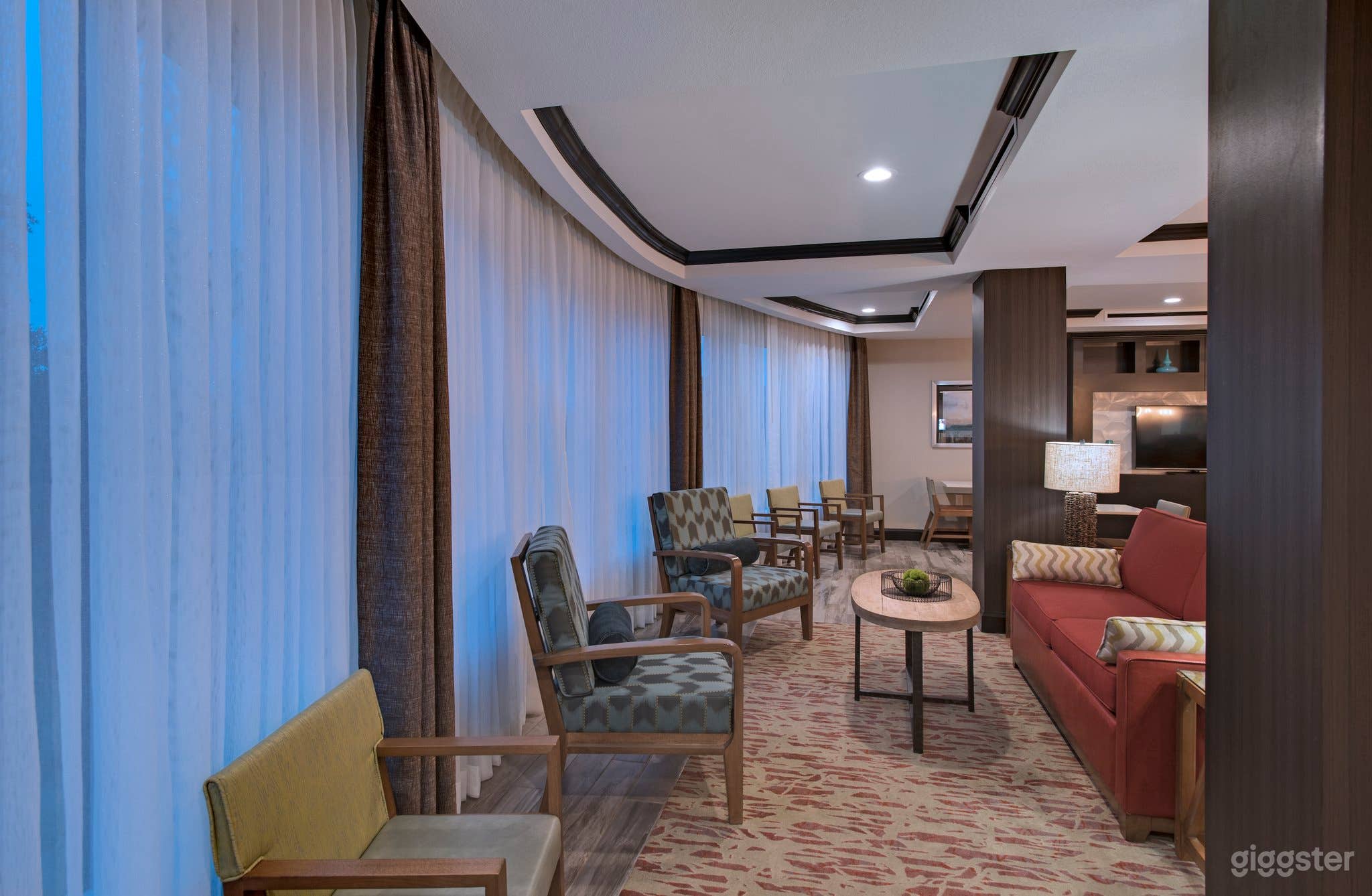 The room is designed for comfort, featuring modern furnishings, adjustable lighting, and climate control. Plenty of power outlets are available for your convenience.