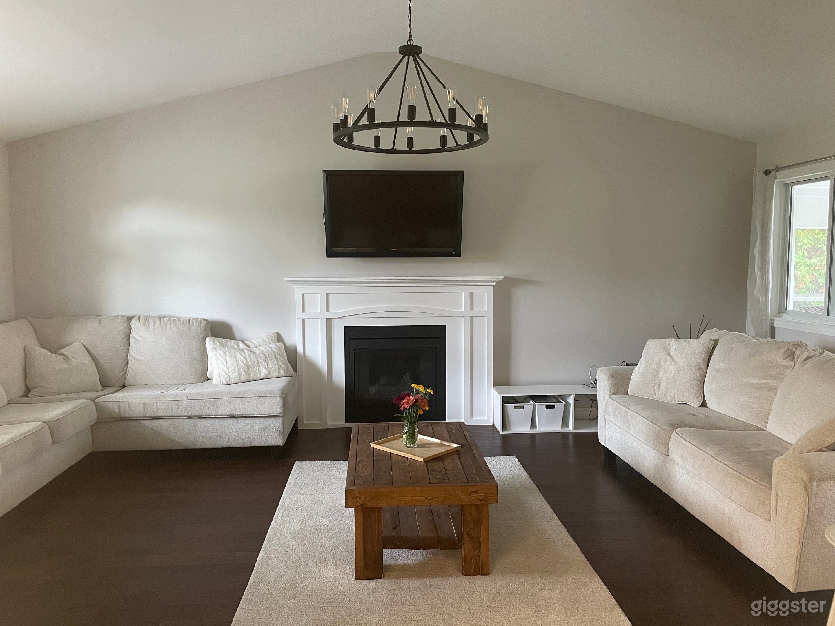 Bright and open concept living room with fireplace and cathedral ceilings