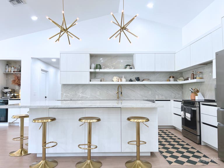  Textured wood grain large modern kitchen with 5 brass bar stools.  