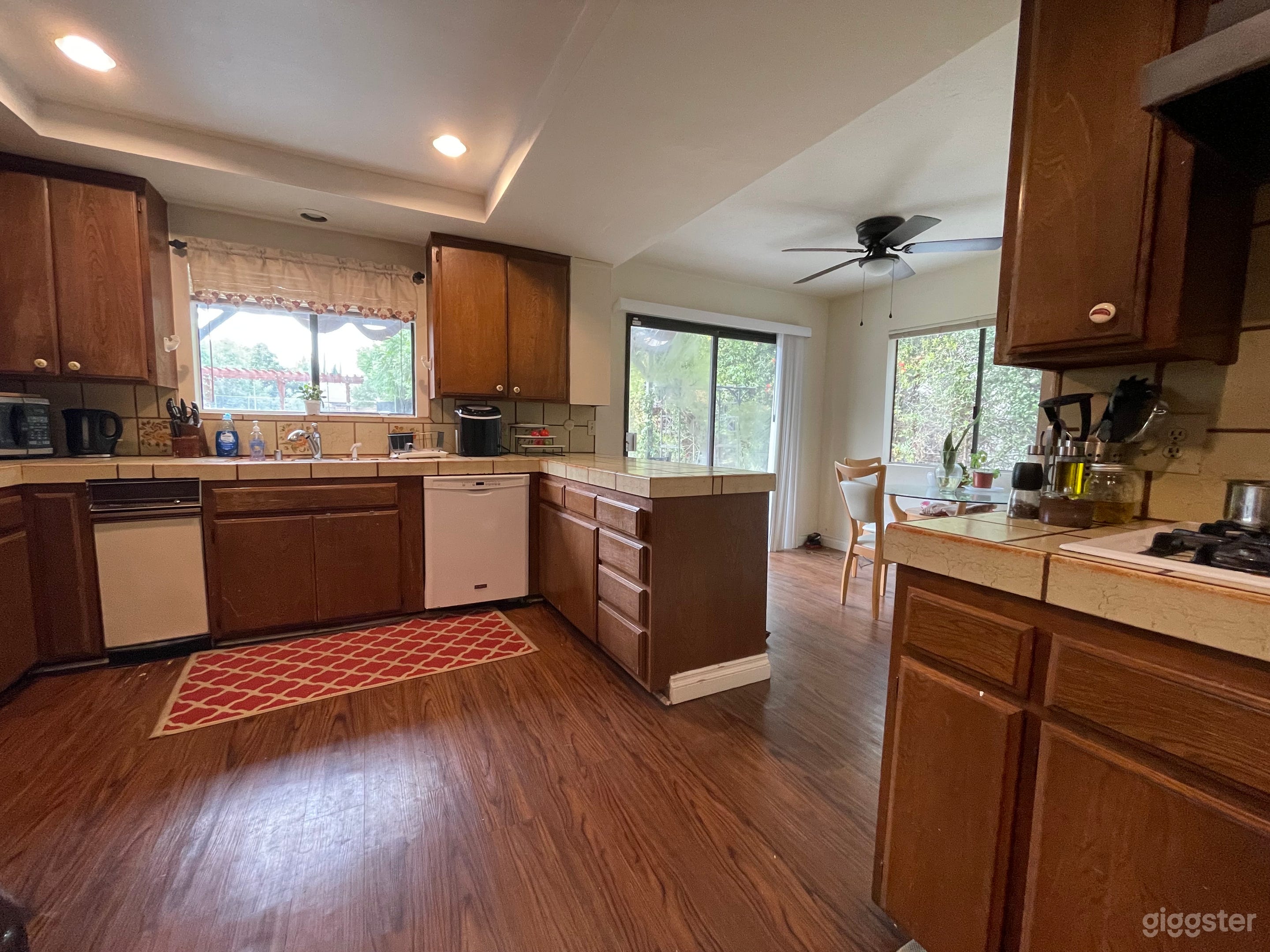 Charming 80’s Kitchen! Wood cabinets, tile countertops and range hood! Photo 1