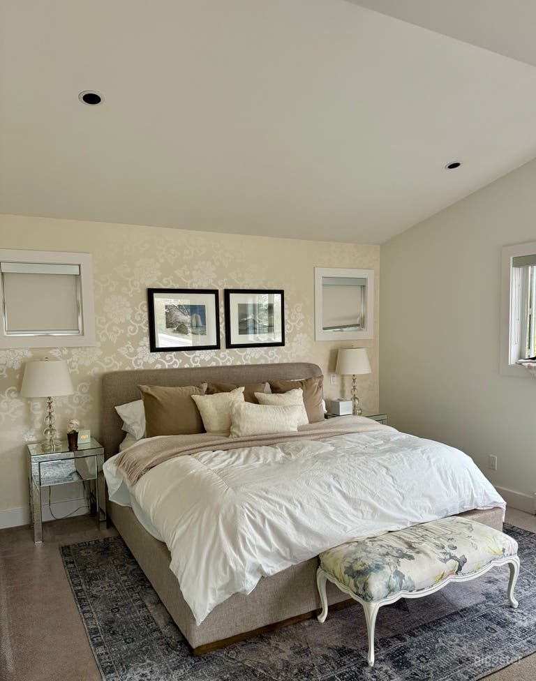  Primary bedroom with Damask wallpaper. Also has  walk-in closet and ensuite. 