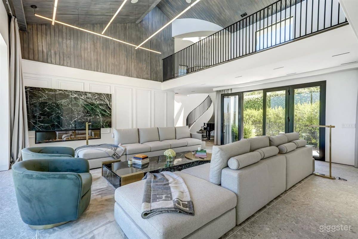 Living room area with marble fireplace and hand crafted wood siding ceiling. 