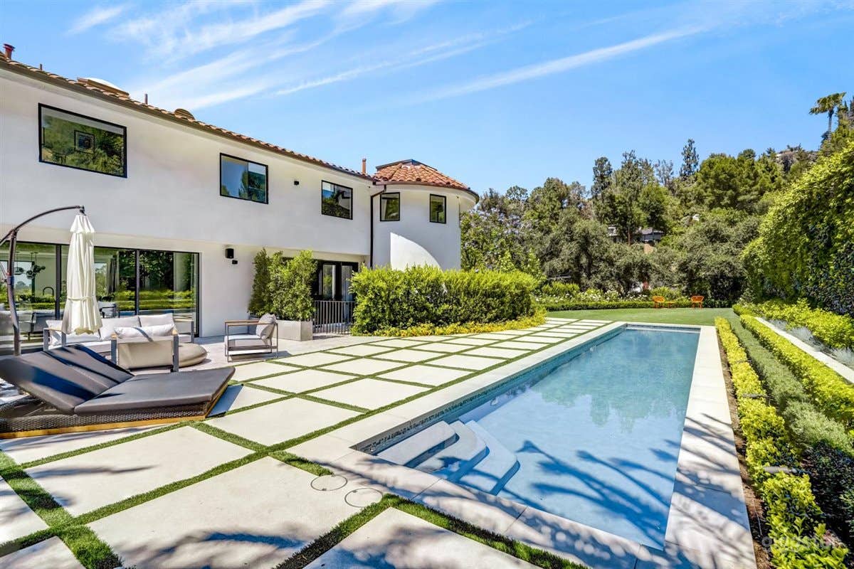Backyard area with lush greens and lap pool