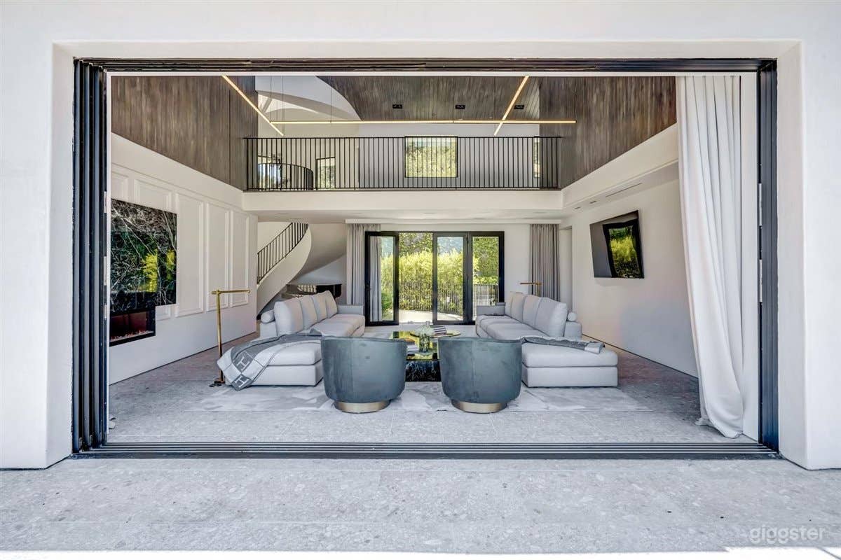Indoor outdoor space with an architecturally curated living room and entry 