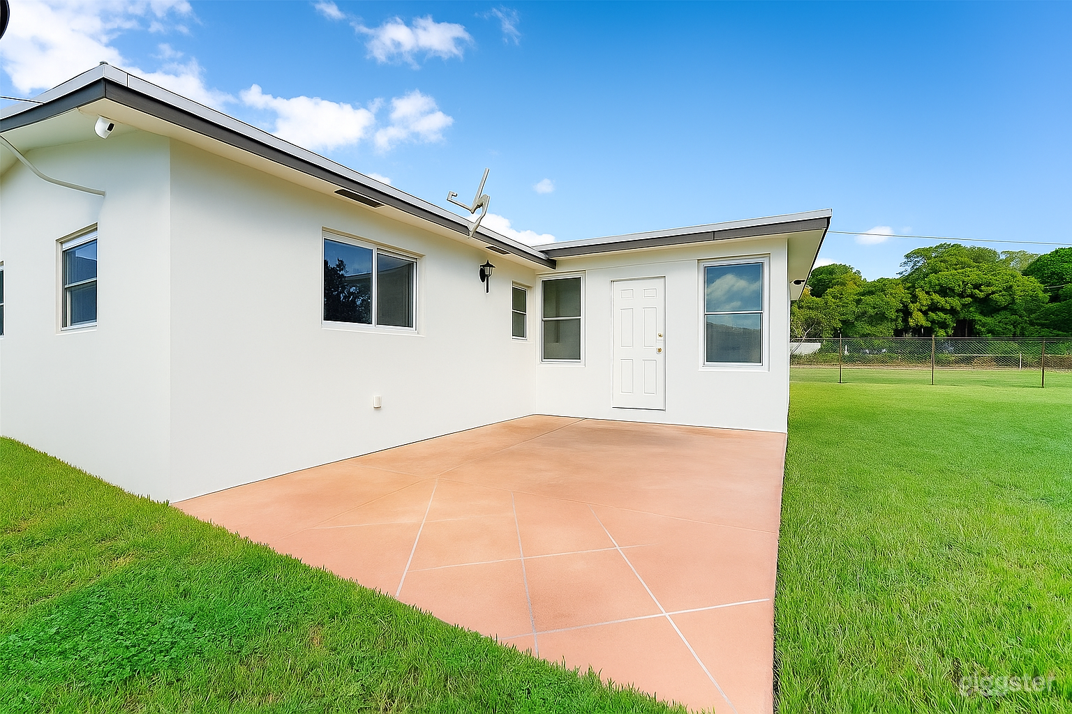 Clean and spacious back patio with a smooth tiled surface, perfect for a bar, food service, or event setup.