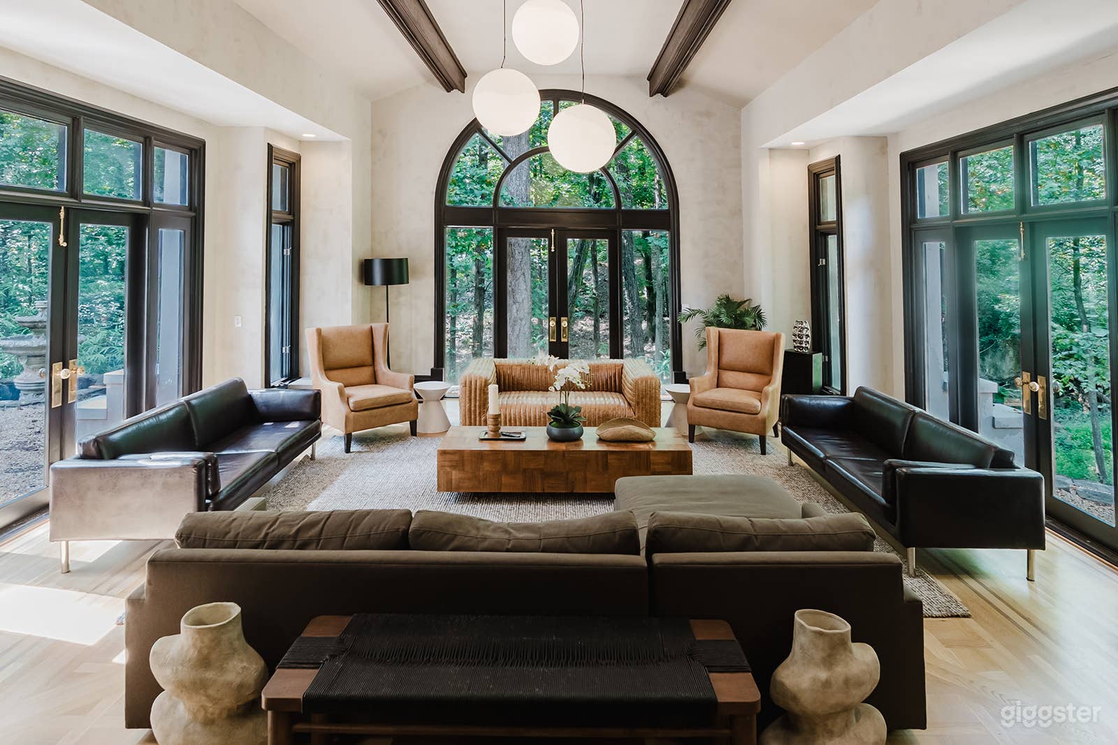 Formal sunken living room with surround views of the forest and stream below