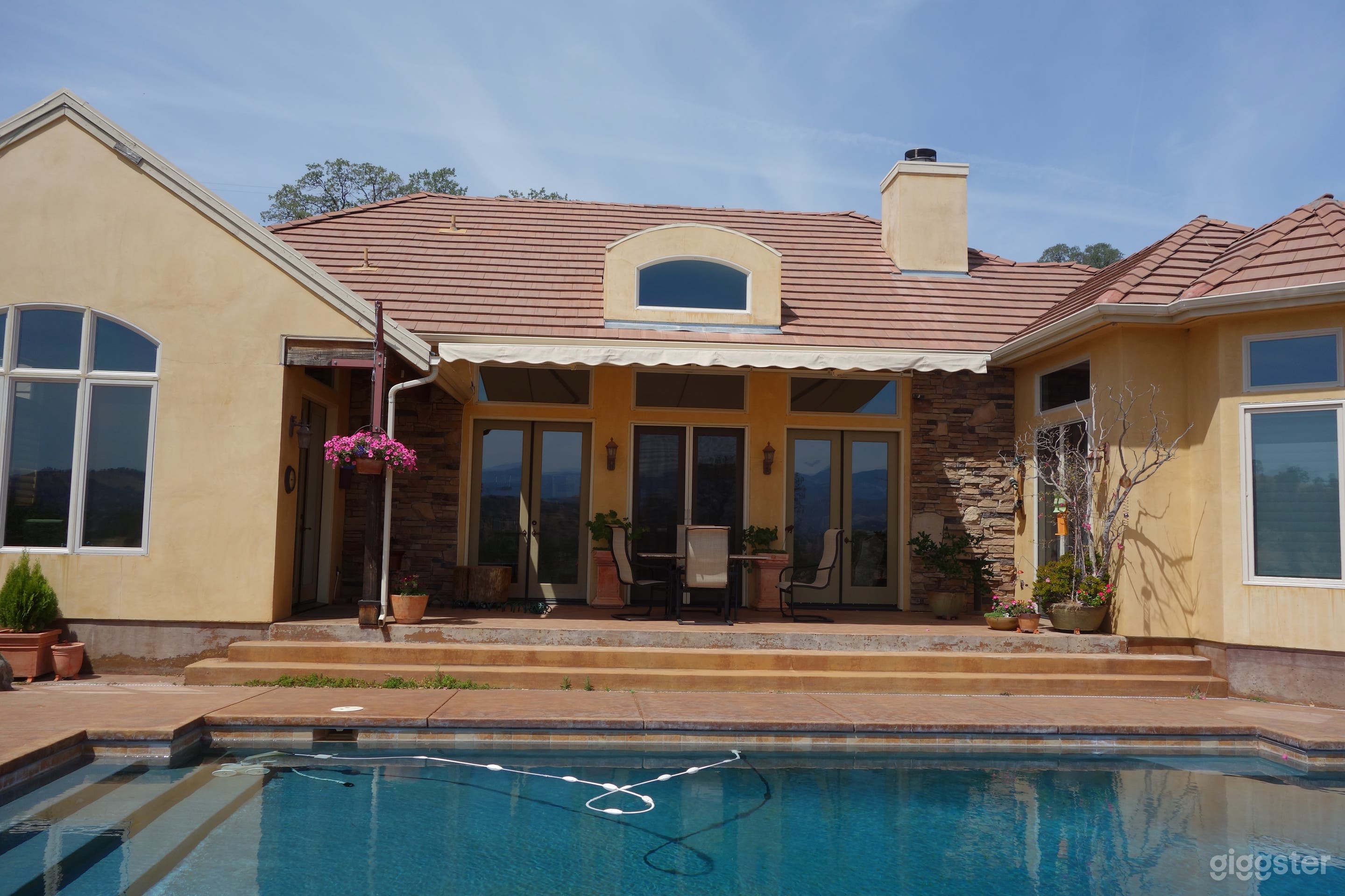 View from back yard.  Back patio with French doors opening to great room, master bedroom and dining area.