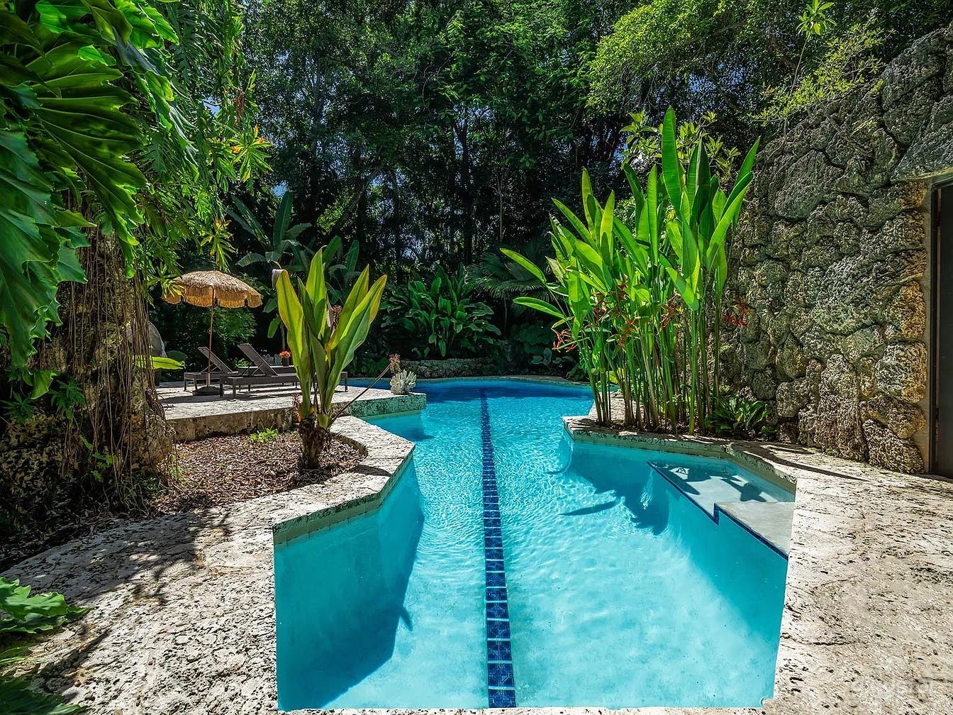 Tropical Freeform Pool with Coral Rock Grottos Photo 2