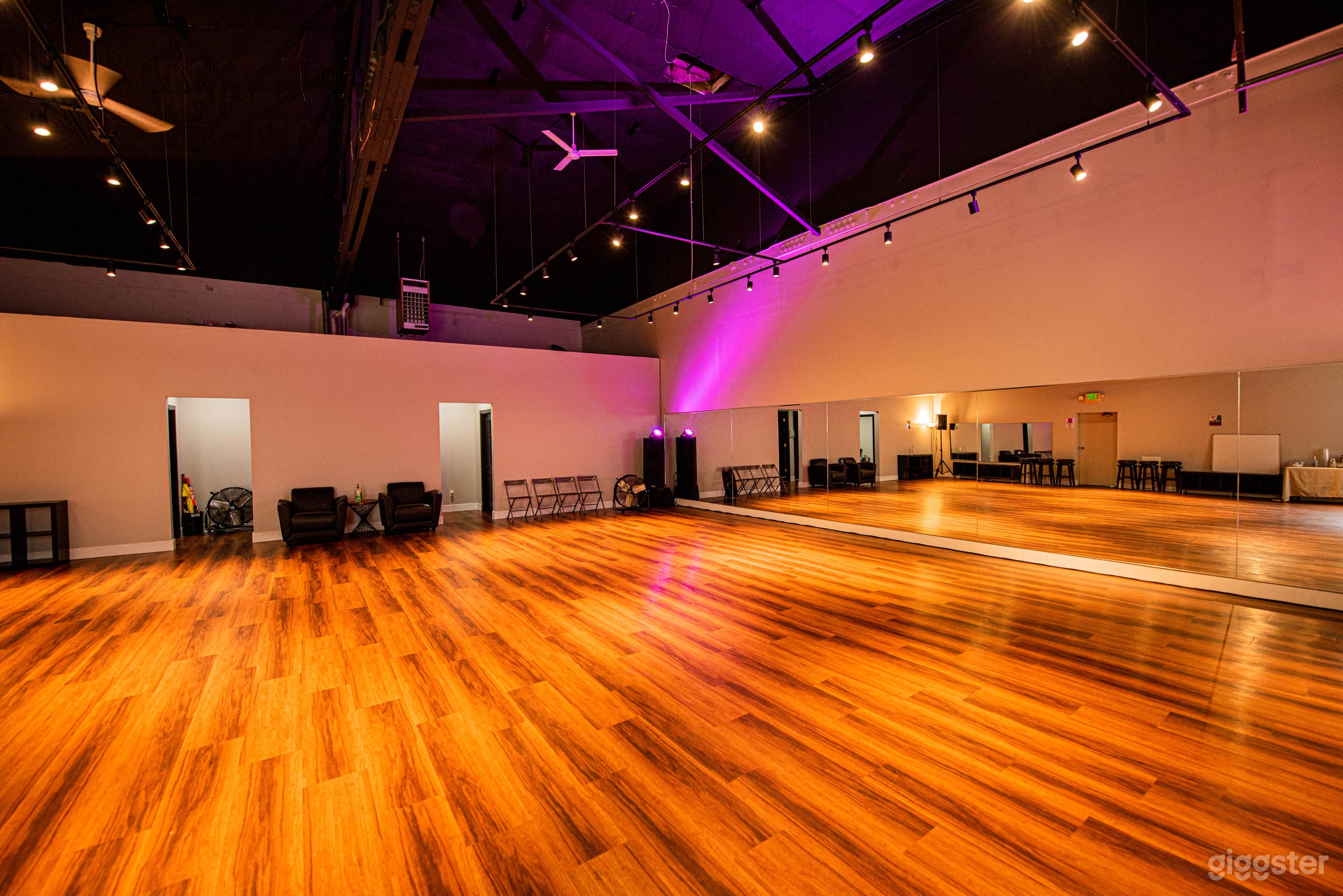 Tall ceilings, open floor, full mirrors.