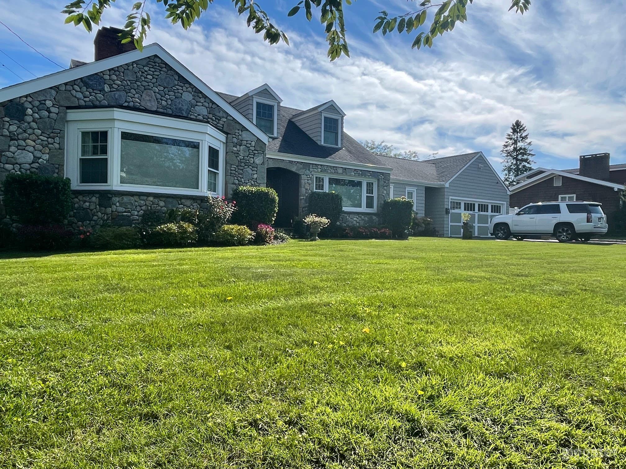 Lovely New England home featuring beautiful stone detail, pristine landscaping and attention to detail. 